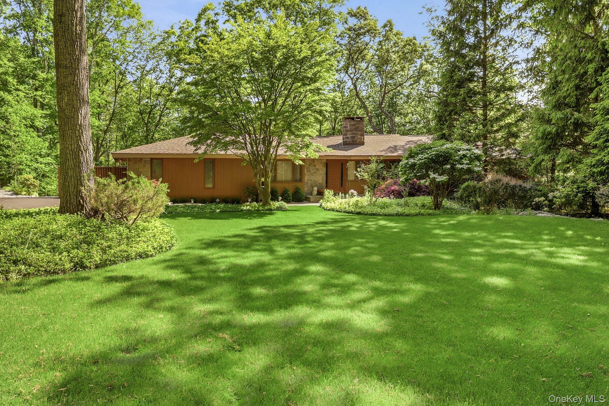 Built in 1962 in the spirit of Usonia, this exceptional mid-century modern residence is being offered for the first time by its original owners. Designed through a unique collaboration with renowned architect Edgar Tafel, Frank Lloyd Wright's longtime apprentice, the home showcases soaring lofted ceilings, a dramatic custom walnut architectural ceiling feature, striking stone accents, and a stunning floor-to-ceiling stone fireplace. Privately set on 2.3 acres on a quiet dead-end road, this architectural gem offers 3 bedrooms, 3 full baths including a primary ensuite, a den, a finished walk-out lower level and expansive decking. An attached two-car garage with a bonus of a separate car barn, ideal as an artist's studio, workshop, or creative retreat. A rare opportunity to own an architecturally significant home that beautifully honors the principles of mid-century modern design while preserving the vision of its original owners. A truly special offering where architectural history and timeless design come together. Home as art.