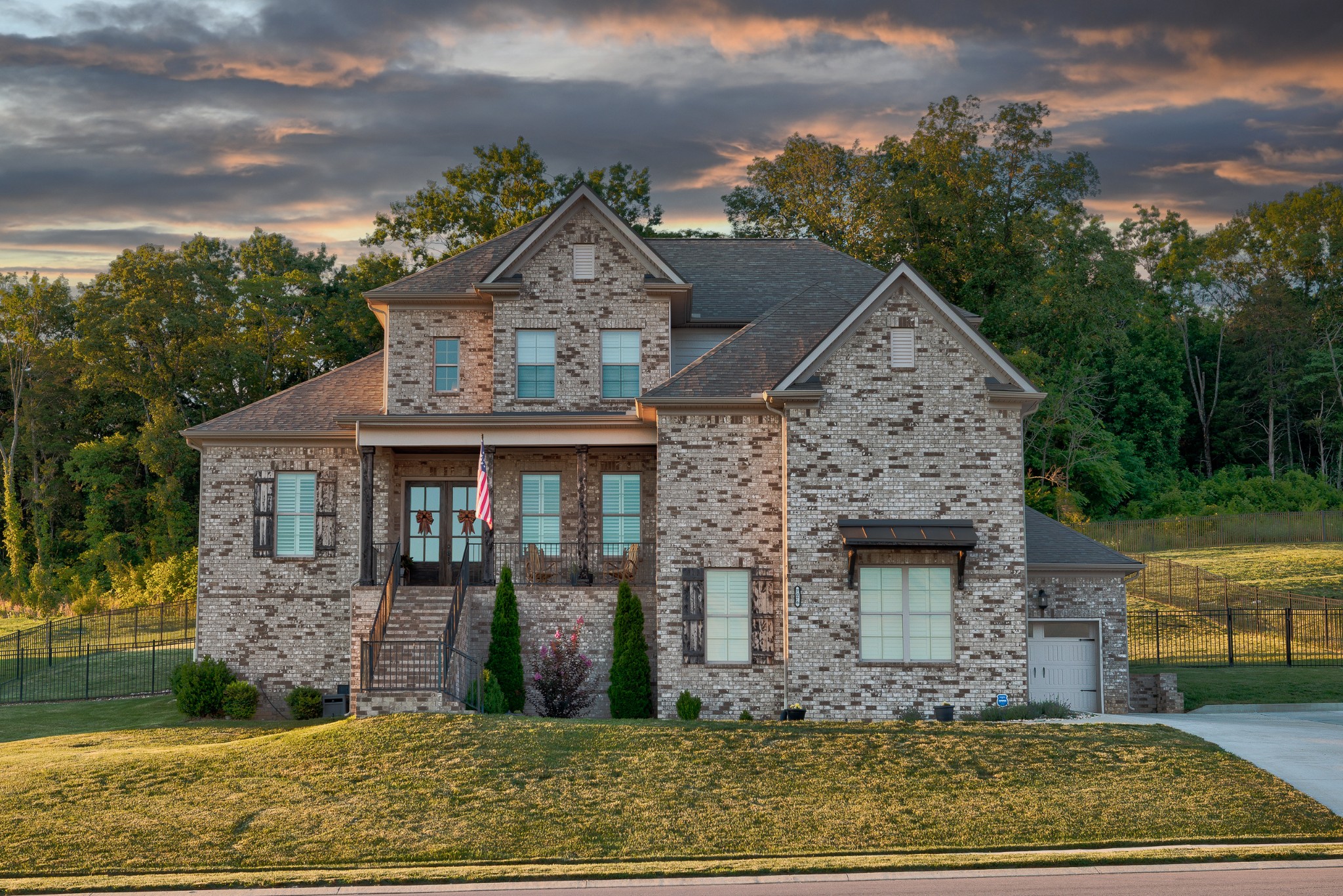 Opportunity meets setting in one of Nolensville's most compelling values. This nearly 3,800 sq ft brick home offers substantial space, a fenced .60-acre homesite, wooded privacy, hilltop scenery and sunset views - all in a sidewalk community with a neighborhood pool. The backyard is the story: expansive, scenic and full of upside. Backing to ~20 acres of HOA-owned woods that is not slated for development, the setting offers a rare sense of long-term privacy. With its tree-lined backdrop and elevated vantage point, the lot invites the possibility of a luxury outdoor retreat with a pool, spa, terraces, walls, landscaping, gardens, fire feature or outdoor kitchen. (Buyer to verify feasibility, HOA approval and site requirements).Inside, a two-story foyer makes a memorable first impression, flanked by a private study and formal dining room. The main level continues with a spacious great room featuring cedar-wrapped ceiling beams, built-ins beside the fireplace, added windows with transoms and pre-wiring for surround sound. The kitchen offers under-cabinet lighting, tile backsplash, breakfast nook, butler's pantry with custom cabinetry and space for a wine fridge, plus a walk-in pantry nearby. The main-level primary suite offers north-facing windows, dual walk-in closets and a standout bath with double rain shower heads, walk-through shower, garden tub and private water room. Upstairs: bonus room, 3 bedrooms, 2 full baths and walk-in closets in each bedroom.Additional highlights include plantation shutters, recessed can lighting, tankless water heater, generator prep, utility sink in laundry, exterior flood lighting, fenced back yard (a $12K investment in 2023), pedestrian garage door, and tandem 3rd-car garage. Zoned for Williamson County Schools including Mill Creek Elementary, Mill Creek Middle and Nolensville High. Convenient to Nolensville's growing retail, dining and amenities. A big home, big lot, beautiful views and an opportunity to create something special.