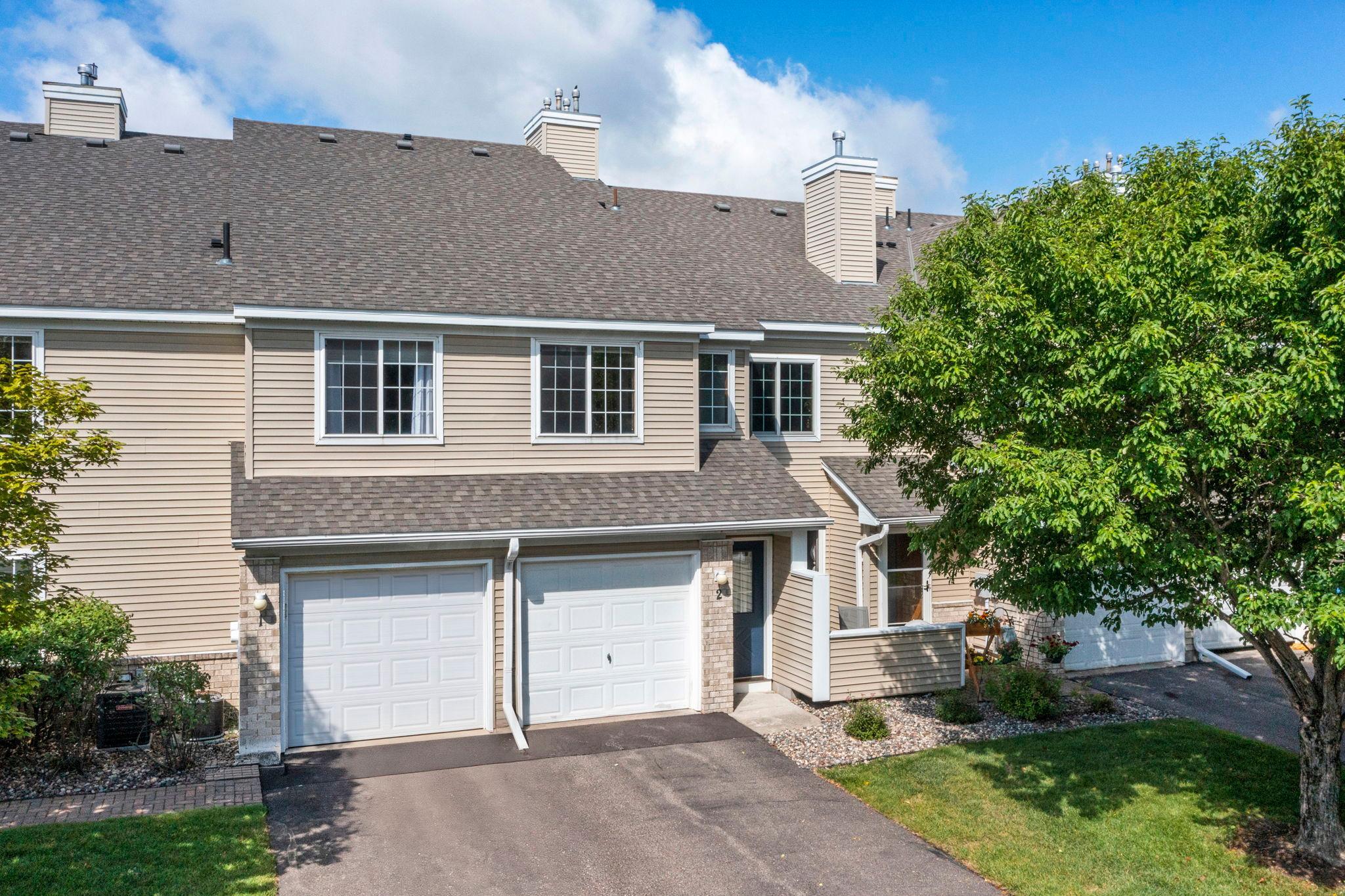 Move right in and enjoy easy, low-maintenance living in the highly desirable Wayzata School District. This beautifully maintained Plymouth townhome offers a bright, open layout with vaulted ceilings, abundant natural light, a cozy gas fireplace, and a private maintenance-free deck.The spacious kitchen features abundant cabinetry, a peninsula with breakfast bar seating, and appliance updates including a new refrigerator and electric range (May 2026) plus a new disposal (2021).Two well-sized bedrooms provide comfortable accommodations, including a spacious walk-in closet in the primary bedroom, along with a nearby full bathroom featuring tile flooring and linen storage.Additional improvements include a Level 2 EV charger (2021), new central AC (2019), and fresh interior paint throughout (June 2026).Ideally located just minutes from Parker’s Lake, scenic trails, parks, shopping, dining, and everyday conveniences. HOA dues cover internet, cable, water, trash, lawn care, and snow removal for true convenience.