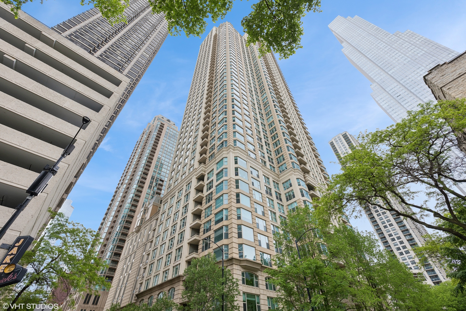 Enter into timeless sophistication in this beautifully renovated, sun-drenched 3-bedroom, 3-bathroom residence at The Fordham - one of Chicago's most prestigious luxury buildings.  Enjoy sweeping north, east, and west exposures with breathtaking views of Holy Name Cathedral and Lake Michigan from two private balconies.  The entire unit was renovated in 2023. No detail was spared. At the heart of the home is a stunning custom-designed kitchen. It showcases handcrafted cabinetry, quartz countertops, under-cabinet lighting, brand-new Miele appliances, a Sub-Zero refrigerator, and two Sub-Zero under-counter wine refrigerators. A Miele washer and dryer add modern convenience.  Just off the main living space, a dedicated office with elegant wood built-ins and pocket doors provides a quiet workspace. The third bedroom has been opened up and is currently used as a sitting room which features additional built-in storage for versatility.  Thoughtful design details include engineered pecan hardwood floors, crown molding, new lighting fixtures, and electric window shades.  The oversized primary suite easily accommodates a king-sized bed and features a custom large closet, an additional shoe closet, and a fully renovated ensuite bath with sweeping city views. Luxe finishes include dual vanities, custom cabinetry, tile flooring, premium lighting, and a large shower with both rain and handheld showerheads.  The spacious second bedroom is perfect for guests and is adjacent to a spa-inspired bath with a dramatic lighted feature wall, soaking BainUltra tub, and high-end finishes. A third full bathroom off the hallway offers a standing shower and custom wood countertops. A smart split floor plan provides privacy between bedrooms.  Additional features include a private storage unit (S309) and two side by side garage parking spaces (P-905 & P-906).  The Fordham is a full-service, amenity-rich building offering 24-hour door staff, an indoor pool, fitness center, private theater, wine cellar, humidor, and more.