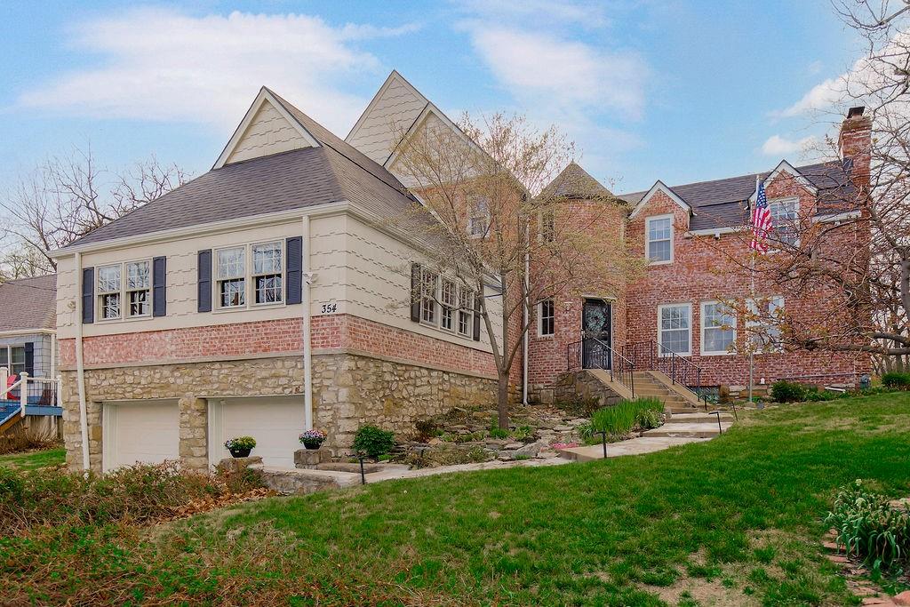 This stunning 4 bed, 3.5 bath home, originally built in 1932, blends timeless old-world charm with thoughtful modern updates. Step through the front door into a unique turret entry with a grand staircase leading to the bedroom level.To the right, the inviting family room features a fireplace and incredible original details. The back hallway offers the perfect mudroom space and access to a beautiful stone patio with pergola, wisteria, and outdoor seating ideal for relaxing or entertaining. A second staircase provides added convenience to the upper level. The chef’s kitchen is a dream, complete with a gas Viking stove, Sub-Zero refrigerator, 2 dishwashers, pantry,& abundant storage. The hearth area includes a  Vermont Casting Winter Warm Oven fireplace to help warm the space, plus room for a large table & gatherings. You will fall in love with the views to the backyard! A formal dining room flows into the impressive great room with vaulted ceilings & a loft space perfect for kids. Upstairs, the updated primary suite offers a walk-in closet, double vanity, beautiful shower, and heated floors. laundry drawer & jewelry cabinet 3 additional bedrooms, 2 full baths, a hidden loft access door, & bedroom level laundry complete the upper floor. The lower level includes a versatile bonus room ideal for a media space, office, or retreat, along with a large basement for storage. Additional features include a 2-car garage & golf cart storage. Enjoy outdoor living with a screened porch, flat backyard with built-in trampoline, & a storage shed. New attic insulation, New roof, gutters w/covers, downspouts  All new exterior paint, Garage floor epoxy coating Dock site #168 for all your water fun. A one-time $40K Lake Quivira membership is required, granting access to this private, gated community with 24/7 security. Enjoy lake activities, golf, tennis, pickleball, pool, sauna, trails, and more. The clubhouse and community spaces create a vibrant, active lifestyle—live where you play!