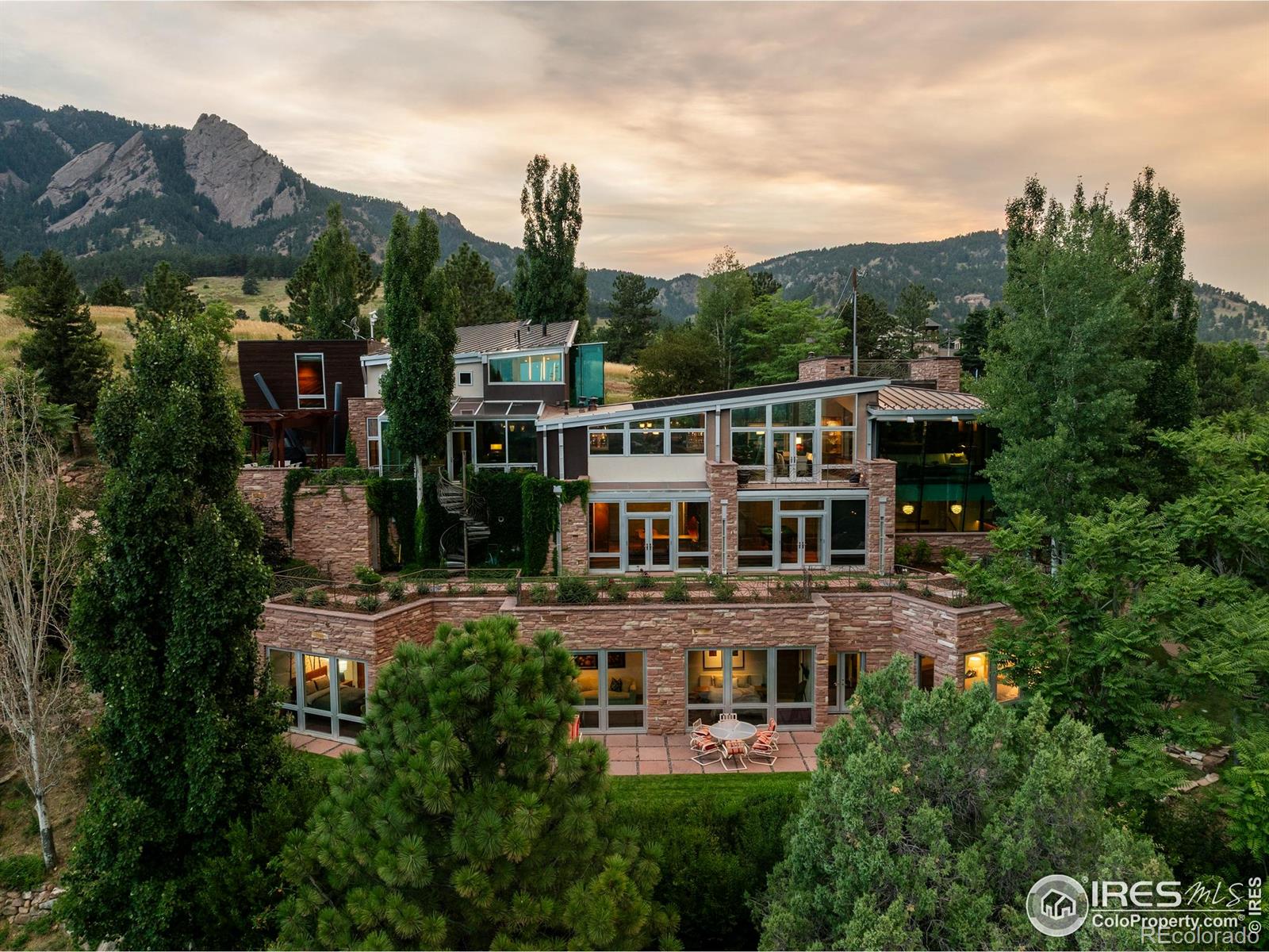 A One-of-One estate carved into the slope of Boulder's iconic Flatirons, offered today at less than half its reproduction cost. Gated, private, and architecturally unmatched, this residence stands at the very peak of Bellevue Drive, Boulder's most exclusive street, where views sweep across Chautauqua Park and the timeless rock faces of the Flatirons. Built with materials sourced and crafted for permanence, flagstone mirroring the Flatirons, hand-carved copper, Honduran mahogany, and walls of green sea glass, this is a home where artistry meets engineering. What sets Bellevue apart is its rarity: one of the few private estates along Colorado's Front Range to offer not just a primary residence but a separate, equally compelling guest home, both integrated seamlessly into the terrain. Behind its gates, the property functions as a true private retreat, with two distinct dwellings shaped by nature and connected to the very fabric of Boulder. With direct access to Chautauqua Park, one of the most storied park lands in the West, protected since the 1800s, your backyard is guaranteed to remain untouched. Beyond architecture and setting, Bellevue is a property that cultivates lifestyle. Mornings begin with private access into Chautauqua. Evenings conclude with recovery in the spa and locker room. Every element serves a purpose. Fitness, wellness, retreat, creation, woven together in a residence that offers both inspiration and privacy. This is not only a home; it is the framework for the life Boulder promises at its highest level. Shaped by terrain, not trends, this is a place where screenplays are written, canvases fill with light, and books begin. Every angle was designed to inspire, while offering a level of privacy rarely found in Boulder or anywhere. Live privately. Create freely. Own the irreplaceable. This is two residences being sold together. 375 Bellevue an ADU/ Carriage House a 1 bedroom, 2 bathrooms, 1 car, 1,373 sq ft of living space, a $1.5 Million value.