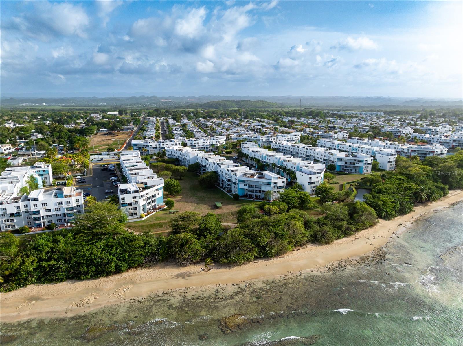 Penthouse unit 594 at Chalets de la Playa Este in Vega Baja offers three levels, 3 bedrooms, 2 full bathrooms, 2 half bathrooms, and two tandem parking spaces. The main level includes the living and dining areas, kitchen, laundry area, half bathroom, and balcony. All three bedrooms and both full bathrooms are on the second level. An interior staircase leads to the rooftop terrace and an additional half bathroom.The floor plan measures 1,395 sq. ft. of gross living area, plus a 90 sq. ft. balcony. The deed describes 1,721.49 sq. ft. of total area. Furniture and equipment shown in the listing photos are included in the sale, subject to a written inventory.The unit is vacant and available for possession at closing. The community has controlled access, pools, recreational areas, and access to the beach. Long-term rentals are permitted; short-term rentals are not permitted. Combined association fees are $196.19 monthly.