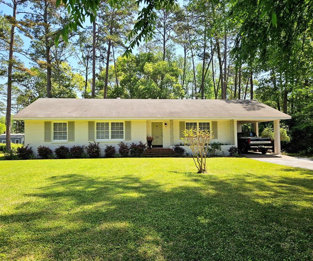 Homes in this area don't come up often—and when they do, they don't usually offer this much space, condition, and location all in one. Just a few blocks from Glen Arven Country Club, Archbold hospital, and schools, and minutes to downtown Thomasville, you're right where you want to be while still enjoying the privacy of a  acre lot with mature landscaping and a beautifully maintained yard. From the moment you walk in, this home feels welcoming and easy to live in. The sitting room flows into a true dining space that can comfortably handle a full table without feeling crowded. The kitchen has been updated with a brand new stove, refrigerator, and microwave, along with a like-new dishwasher, and features a breakfast bar that keeps everything connected. It opens into a spacious living room with custom built-ins—perfect for everyday living, a second gathering space, or just a quiet spot to relax. From there, step out through the sliding glass doors onto the patio and take in the backyard, complete with a workshop with power and exterior water that's ready for whatever you have in mind. The outdoor space is just as appealing, with established fruit trees and plants including lemon, peach, orange, and blueberry—adding both charm and something you can actually enjoy year after year. The irrigation system is on its own water meter, making it easy to keep everything green without the added expense on your main usage. The primary suite gives you plenty of room to spread out, with a very spacious closet and private bath with a step-in shower. Guest bedrooms are equally spacious with great closet space. Throughout the home, you'll notice the added crown molding and custom door casings that elevate the overall feel, along with LVP in the main areas and original hardwood floors in the hall and bedrooms that are in excellent condition. This home checks the boxes that matter—fresh interior and exterior paint, a true walkable attic, an attached carport with a laundry room, updated fixtures, a 5-year-old HVAC, and gas heat and water heater. The sprinkler system has been maintained, and the sellers will provide a termite bond prior to closing. This is the kind of home people wait for in this location—well kept, move-in ready, and offering space both inside and out. If it's been on your list, now's the time to come take a look before someone else does.