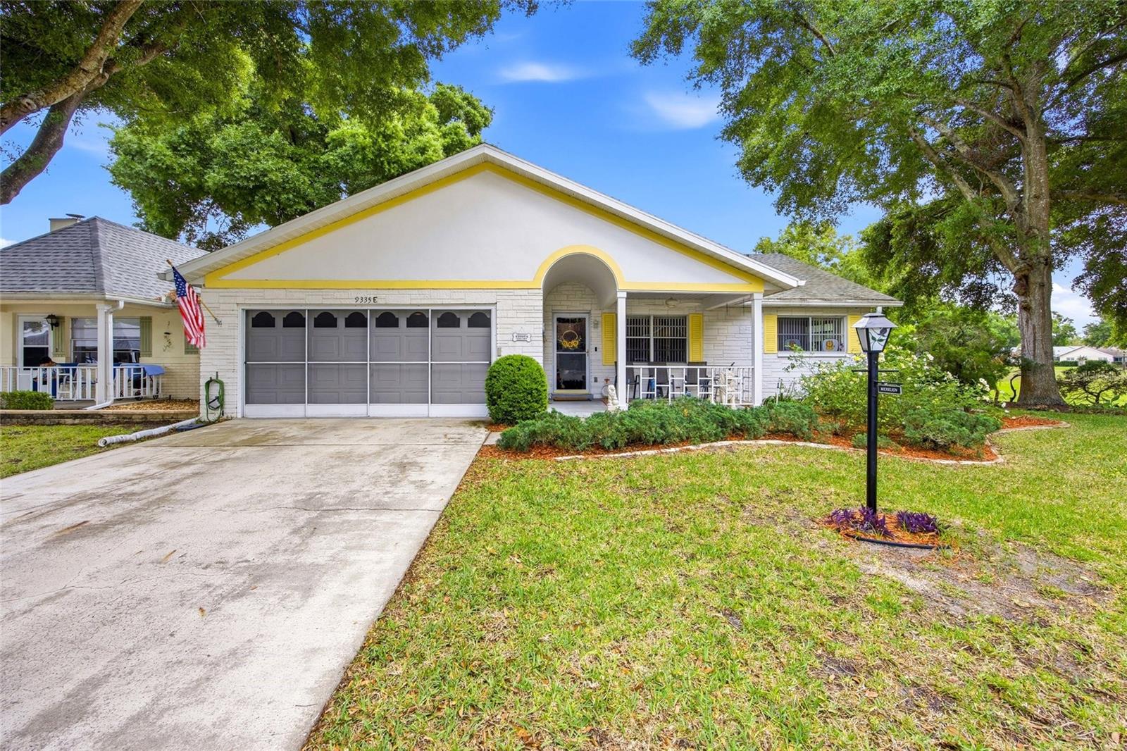 One or more photo(s) has been virtually staged. Welcome home to this spacious end-unit Bostonian in the highly desirable 55+ golf community of On Top of the World in Circle Square Woods. Offering 2 bedrooms, 2 baths, and 1,772 living sq ft, this villa combines comfort, privacy, and easy Florida living. From the inviting large front porch, perfect for morning coffee and neighborly chats, to the private rear screened lanai, this home is designed to enjoy both indoor and outdoor living. Inside, you'll love the no-carpet flooring throughout, comfortable living room, and an impressive chef-inspired kitchen featuring resurfaced dual-tone cabinetry, (most with pullout drawers) abundant counter space, a large island/bar, and newer stainless-steel appliances. The expansive Florida room creates the perfect setting for entertaining family and friends. The spacious primary suite offers a walk-in closet and an updated bath with step-in shower and rain glass enclosure, while the guest bedroom is ideal as a bedroom or home office. Additional highlights include a 2-car garage, washer and dryer, extra refrigerator, HVAC replaced in 2015, and roof updated in 2023. A wonderful opportunity to enjoy the active lifestyle, amenities, and charm of Ocala's soughtafter On Top of the World community.