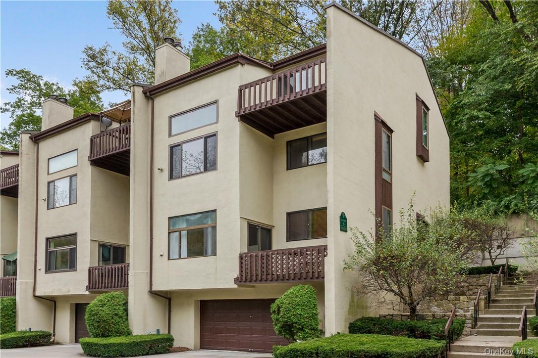 Welcome to Chestnut Oaks. Corner unit Townhome located in building 5 featuring 2 bedrooms, 2 full baths, fireplace, attached garage and balcony.  Located in the heart of Chappaqua and close to train, town and schools.  Renovated in 2010 with new dine-in kitchen, granite counter tops, stainless steel appliances, hardwood floors, renovated primary bathroom, custom walk-in closet, new washer/dryer and Bose speakers.  Community outdoor pool and tennis.