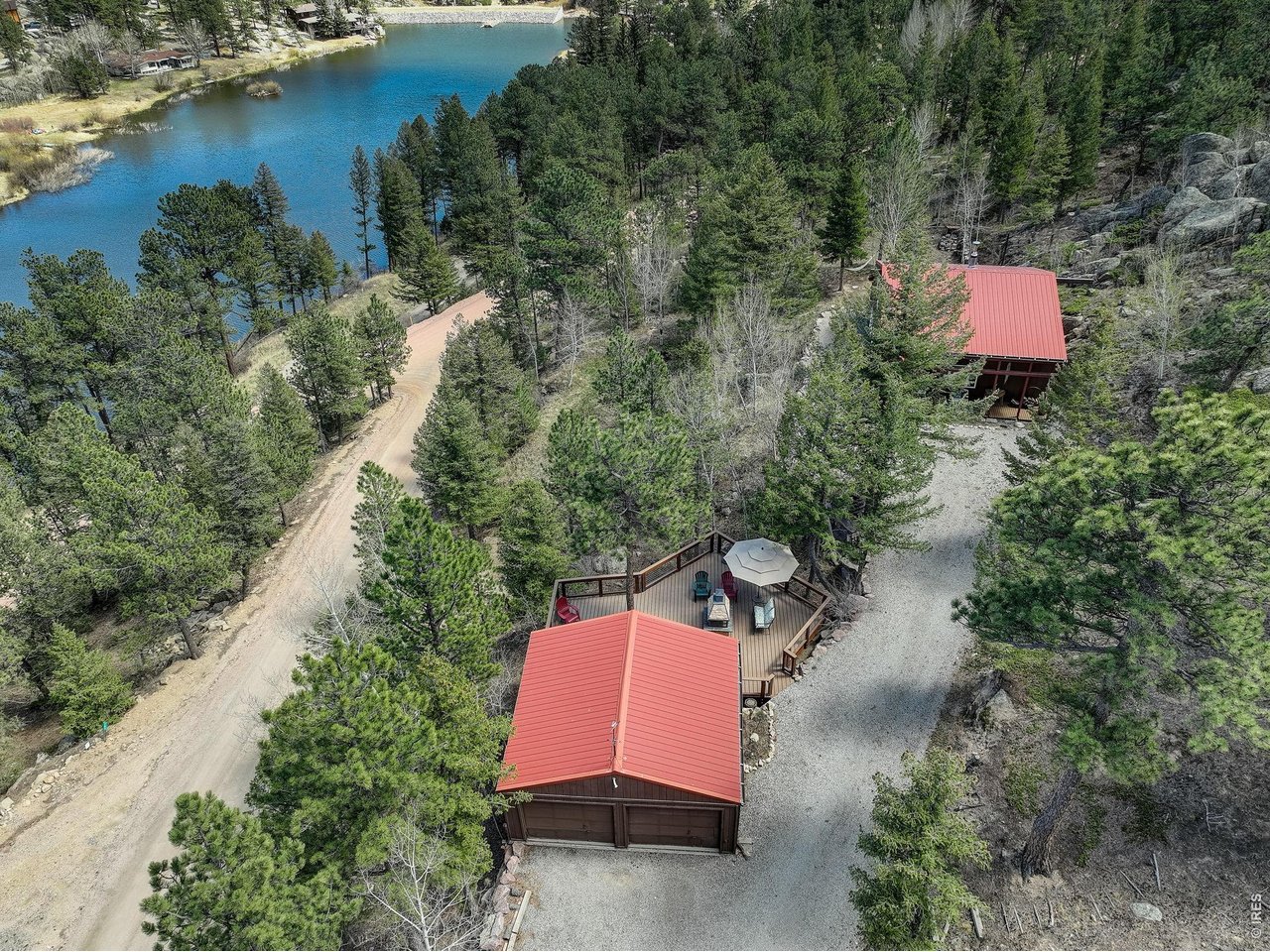 Experience the best of Colorado mountain living in this exceptional move-in ready retreat located in the highly sought-after gated community of Big Elk Meadows. Set on a private lot with stunning mountain views, abundant wildlife, and direct access to year-round outdoor recreation, this property offers the perfect blend of privacy, comfort, and adventure. Furnishings are negotiable and may be included with sale, creating a rare turnkey opportunity for buyers seeking a primary residence, second home, vacation getaway, or investment property in the Colorado mountains. Located within walking distance to two private community lakes, residents enjoy exclusive access to six stocked fishing lakes, non-motorized boating, heated swimming pool, tennis and pickleball courts, horse facilities, shooting range, and miles of scenic trails with direct access to national forest land. Conveniently located with easy access to Lyons, Estes Park, Rocky Mountain National Park, and Roosevelt National Forest, enjoy endless hiking, biking, fishing, wildlife viewing, and outdoor adventure. Inside, the bright open-concept floor plan connects the kitchen, dining, and living spaces, anchored by a cozy wood-burning fireplace. Upstairs features three bedrooms plus a versatile loft ideal for guests, office space, or additional sleeping accommodations. Truly a rare opportunity to own a turnkey mountain retreat in one of Colorado's most unique private mountain communities.
