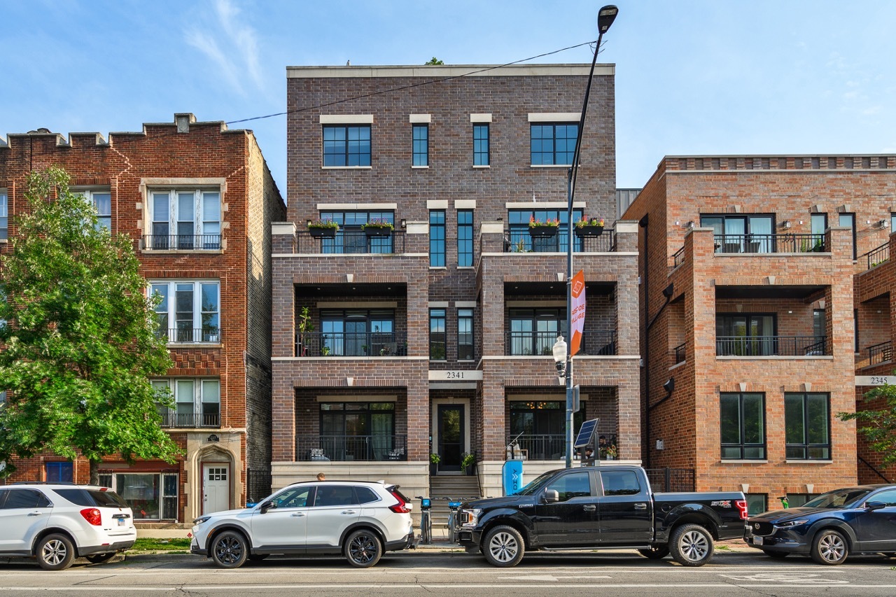 Designer-owned and extra-wide, this Roscoe Village duplex lives like a single-family home with approximately 3,000 sq ft across two levels featuring 4 bedrooms, 2.5 baths, and three private outdoor spaces, including an expansive garage roof deck. A gracious foyer leading into the oversized living room immediately sets this home apart and showcases the extra-large floor plan. The living room is large enough to accommodate a dining area or additional seating, plus it is accented by a fireplace, custom Restoration Hardware drapery, and direct access to the front grilling terrace with gas line. The showpiece kitchen impresses with a Sub-Zero refrigerator, Wolf six-burner range, seating for four at the island, ceiling-height cabinetry, designer lighting, and a butler's pantry featuring glass display cabinets, beverage fridge, and second sink. Adjacent, a generous family room also offers flexible furniture placement with room for additional dining space, an office nook, and everyday unwinding space that leads to the back terrace and the expansive garage-roof deck, complete with irrigated planter boxes and room for alfresco dining and lounging. All four bedrooms are conveniently on the same level and offer ample closet space and maximum living space.   The luxurious primary suite accommodates a king bed and sitting area, complemented by a custom walk-in closet and spa bath with soaking tub, steam shower with bench, and a dual vanity. Constructed by premier developer Avison Young with rare concrete-between-floor construction for quiet living, the home is further refined by crown molding, hardwood floors, integrated speakers, composite decking on all three decks, and an EV-ready garage space. Plus, recent seller updates include new LED recessed lighting throughout, a new LG washer/dryer, updated kitchen and bath hardware, a custom stair runner, designer wall treatments, and hypoallergenic carpeting. Set within a well-run, all-brick building in the AUDUBON SCHOOL DISTRICT and just steps from neighborhood favorites like Le Sud and Turquoise Cafe, Hamlin Park, the farmers market, and plentiful daycares and grocery options-with easy guest parking-this residence offers an unparalleled blend of space, style, and indoor/outdoor living in the heart of Roscoe Village.
