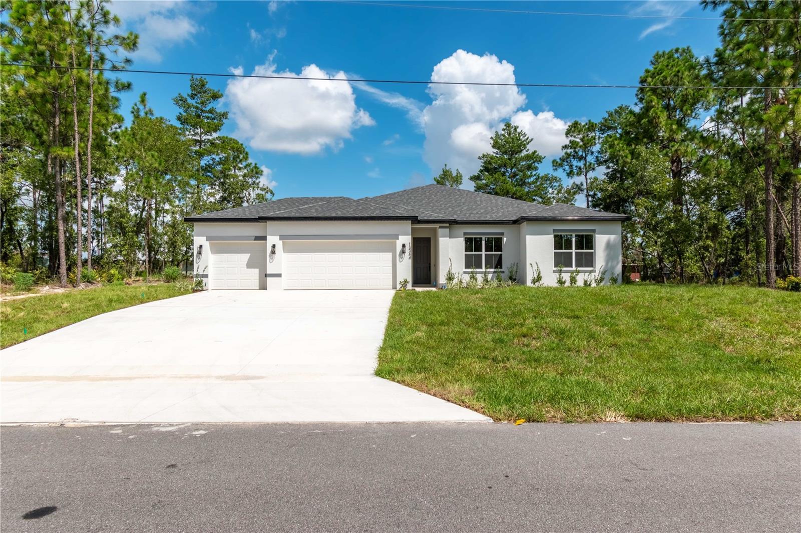 Ask about our Builder Incentives including interest rate buydown and closing cost assistance! Impeccably designed BRAND-NEW CONSTRUCTION  4-bed 3-bath-3-Car Garage home located in a great central Marion Oaks location close to everything Ocala has to offer! From the moment you arrive you will notice the difference with volume 9'4'' ceilings throughout the entire home. The main living space is centered around the Living Room with stunning 8' triple panel sliding glass door that overlooks the covered lanai which perfectly integrates the indoor/outdoor living space. The kitchen showcases Dolce White Quartz countertops, Samsung stainless steel appliance suite (3 Year Warranty), 42'' upper cabinets, entertaining island, and French doors with access to the cover lanai. Owner's Suite features trey ceiling, oversized dual sink vanity, tastefully designed shower with glass enclosure, and his & hers walk-in closets. All guest bedrooms are well sized with ample closet space. The private Guest Suite has an en-suite bathroom making it perfect for a Guest room or JR. Suite. Both Guest bathrooms feature tub/shower combo with floor to ceiling tile as well. Spacious Laundry room with an additional linen closet for added storage, plus the washer and dryer are included in the sale! Don’t miss your opportunity to make this house your HOME…Schedule your private tour today!