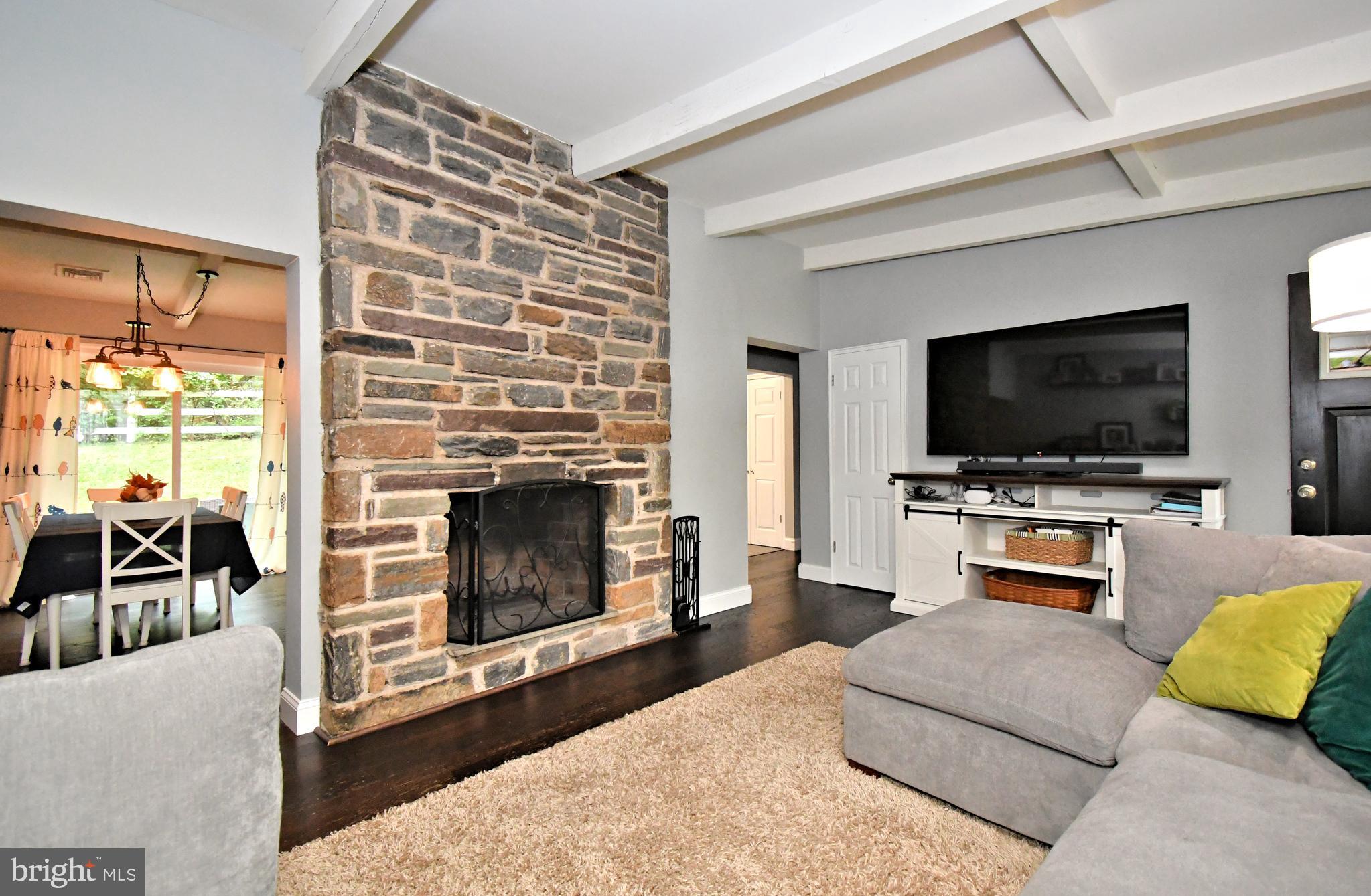 Immediate possession !!! Welcome to 897 Croton Road, a beautifully updated 4‑bedroom, 2‑bath ranch-style home nestled on a 0.43‑acre lot in the  Wayne section of Upper Merion.  Step inside to an inviting floorplan featuring a bright living area anchored by the wood burning stone fireplace and a  remodeled kitchen with tile flooring, rich wood cabinetry, granite countertops, a subway tile backsplash and stainless-steel appliances including a 5‑burner gas stove. The primary bathroom has recently been fully remodeled with decorative tile surrounds, inlay details and contemporary finishes. The dining area opens via sliding glass doors to a paver patio, ideal for indoor-outdoor living and entertaining. A family room/ playroom addition off the dining area  provides additional flexible living space. Pitched ceilings and exposed beams create an open airy architectural appeal. The home includes an oversized, built‑in one‑car garage with interior access. Major mechanicals are modern: gas heat, central air and updated systems as well as  total roof replacement in 2020.  Well‑maintained grounds surround the home, featuring a fully fenced-in rear yard that offers mature landscaping and privacy. Enjoy walking distance  to the McKaig Nature Center dedicated to environmental education and providing a space for the community to appreciate nature ,  top-rated schools, shopping, and major commuter routes — all from a peaceful, tree-lined setting. With tasteful updates, convenient one floor living , generous lot size and  prime location in Wayne with easy access to local amenities, this home is ready for its next chapter. Easy to show- make your appointment today!