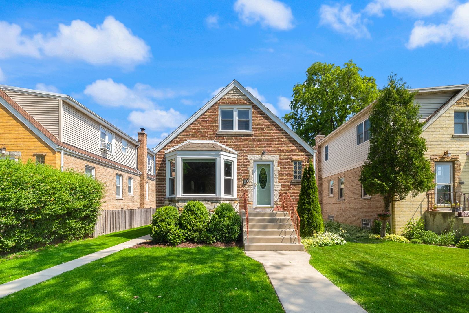 Beautiful all-brick Cape Cod in the heart of Edison Park on an extra-large lot, offering a rare blend of charm, space, and thoughtful updates. Curb appeal shines with classic brickwork, newer front steps, entry walk, side path, landscaping, and a front bay window. Step into a spacious foyer with coat closet, leading to a sun-filled living room with hardwood floors and large picture windows. The formal dining room connects to a stylish, updated eat-in kitchen featuring granite countertops, 42" dark maple cabinets, tile flooring, stainless steel appliances, and generous table space. An enclosed back porch (excellent as a mud room or sunny office!) with built-in storage provides direct access to the yard. The flexible floor plan includes two bedrooms on the main level, two additional bedrooms upstairs (one currently used as a massive walk-in closet), and a full bathroom on each level-three in total. The finished walk-out lower level expands your living space with a tiled wet bar, large family/media room, and open 16x14 playroom with rubber mat flooring over tile-perfect for kids or a home gym. Outside, enjoy a fully fenced backyard with both green space (touch some grass!) AND an expansive concrete patio. The 2.5-car detached garage includes a party door, classically Chicago and perfect for fully enjoying your space with friends and family. Walk-out basement stairs were replaced with concrete steps, and a newer sump pump, ejector pump, and gutters give you confidence for years to come.  Additional benefits include central air, beautiful hardwood floors throughout, built-in storage upstairs and in the porch, jetted tub, tiled walk-in shower, and newer washer/dryer. Built around 1953, this home sits in a prime location near Metra, shops, dining, parks, and easy Blue Line access. Tender loving care shows in every detail-don't miss this versatile and move-in-ready Edison Park gem.