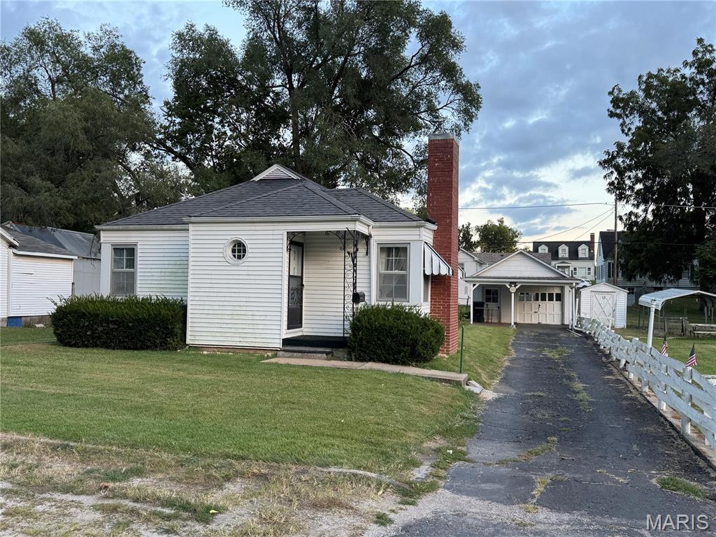 1920s bungalow with extra lot, chock full of character & ready for your personal touches! 1441 sq ft main level. Living room with fireplace and a large separate family room. Detached garage with workshop space and covered patio area. Large yard, partial fencing, sheds and extra lot adjacent with alley access - enjoy a large garden or even sell extra lot for a new build! Old carpet has been pulled to make it easier to install new to suit your tastes AND even revealed some wood floors. Have your preapproval? Schedule your showing today! Need help getting connected to a lender? Just ask!
