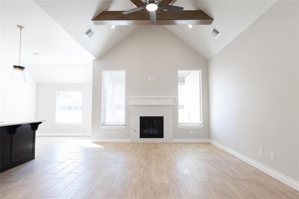 FENCING AND BLINDS INCLUDED! This Blue Spruce Bonus Room 1 floor plan includes 2,640 Sqft of total living space, which features 2,350 Sqft of indoor living and 290 Sqft of outdoor living space. There is also a 590 Sqft, three car garage with an in-ground storm shelter installed. This home offers 4 bedrooms, 3 full baths, 2 covered patios, a large bonus room, and a utility room. The great room welcomes a pristine cathedral ceiling with a crows feet detail, a ceiling fan, excellent wood-look tile, rocker switches throughout, Cat6 wiring, and large windows. The kitchen supports stainless steel appliances, a 5-burner cooktop, 3 CM countertops, a center island with a trash can pullout installed, well-crafted cabinets to the ceiling with under cabinet lighting and cabinet hardware installed throughout, exceptional pendant lighting, and a separate walk-in pantry. The primary suite features a sloped ceiling with a ceiling fan, windows, and our cozy carpet finish. The attached primary bath hosts separate vanities with framed mirrors, a European walk-in shower, a free-standing tub, a private water closet, and a HUGE walk-in closet. Outdoor living has a wood-burning fireplace, a gas line, and a TV hookup. Other amenities include our healthy home technology, a tankless water heater, a whole home air filtration system, R-44 insulation, and so much more!