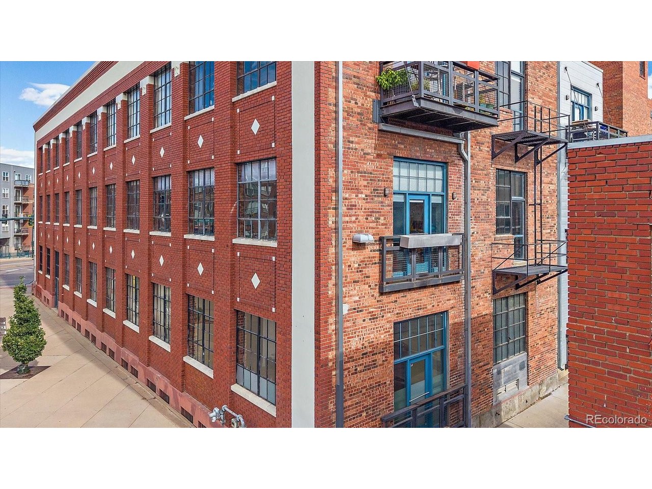 Not all lofts are created equal! Discover an extraordinary 2,048-square-foot residence in the heart of Denver's RiNo Art District, where authentic industrial architecture meets the freedom to live beautifully each day. Set inside the former Benjamin Moore Paint Company building, dating to 1933, this striking three-bedroom, two-bath loft celebrates its heritage with exposed brick, substantial timber columns, soaring ceilings, polished concrete floors, and dramatic factory-style windows. Sunlight pours into expansive living and dining areas, creating an unforgettable setting for entertaining, displaying art, or simply enjoying the character of a true Denver loft. The open kitchen features a generous island, ample cabinetry, pantry storage, and a natural connection to the gathering spaces. A remarkable central flex area offers room for a home office, cocktail lounge, gallery, or creative studio without sacrificing the bedrooms. The spacious primary suite includes an en-suite bath with dual vanities and glass-enclosed shower, while two additional bedrooms and a full bath accommodate guests or changing needs. Enjoy the ease of single-level living, in-unit laundry, secure building entry, elevator access, and TWO parking spaces: one garage space and one covered carport space. Fresh interior paint and refinished floors make the loft ready for its next chapter. Beyond your door, experience the galleries, restaurants, breweries, music, murals, and creative energy that define RiNo, with downtown Denver nearby. This is more than a place to live: it is a distinctive piece of Denver history, with generous proportions, remarkable architectural texture, and the versatility to make it entirely your own. If you have been searching for an authentic timber loft rather than an ordinary condo, put 2500 Walnut Street #202 at the top of your list. Schedule a private tour and experience the scale, light, and unmistakable personality for yourself!