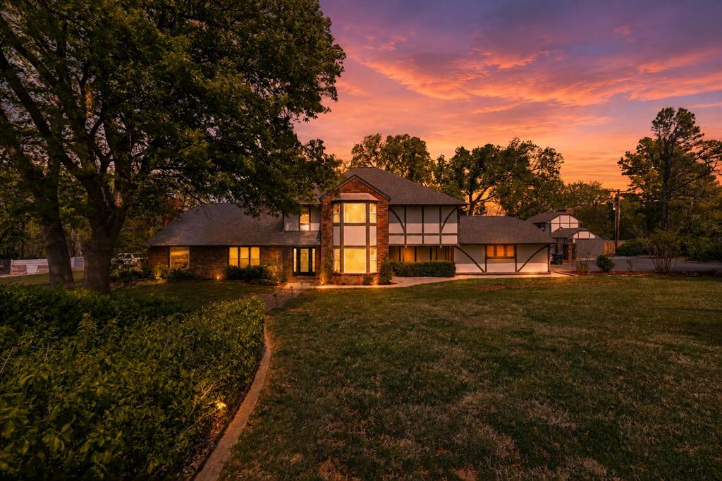 Tucked at the end of a quiet cul-de-sac on two private, tree-lined acres, this distinctive Tudor-style home offers a rare combination of character, space, privacy, and convenience in Norman. The backyard includes a pool with diving board, newly updated decking, and a separate pool house create an incredible setting for summer days and evenings with friends. Complete with a full bath and kitchenette, the pool house offers exceptional versatility as guest quarters, a home gym, art studio, private office, or entertaining space. Beyond the pool, the expansive lower lawn provides even more room to play, gather, garden, or simply enjoy the peaceful wooded setting. Inside, engineered hardwood floors carry throughout the main level where you will find two living areas, dedicated study, formal dining, half bath and the primary suite. The beautifully updated kitchen anchors the home with an oversized island, gas cooktop, pull-out cabinetry, abundant storage, and a spacious walk-in pantry. The primary suite is truly a retreat, featuring its own fireplace, sitting area, and private patio access overlooking the property. Two sets of stairs will take you to the second story where you will find three generously sized bedrooms each offer large walk-in closets, including one with an en suite bath. A substantial flex room adds even more possibilities for a game room, hobby space, additional office, or exceptional storage. With two acres of mature trees, multiple indoor and outdoor living spaces, a pool and pool house, and a location that offers both seclusion and easy access to Norman, this is a property that is difficult to replicate. Private, versatile, and full of character!