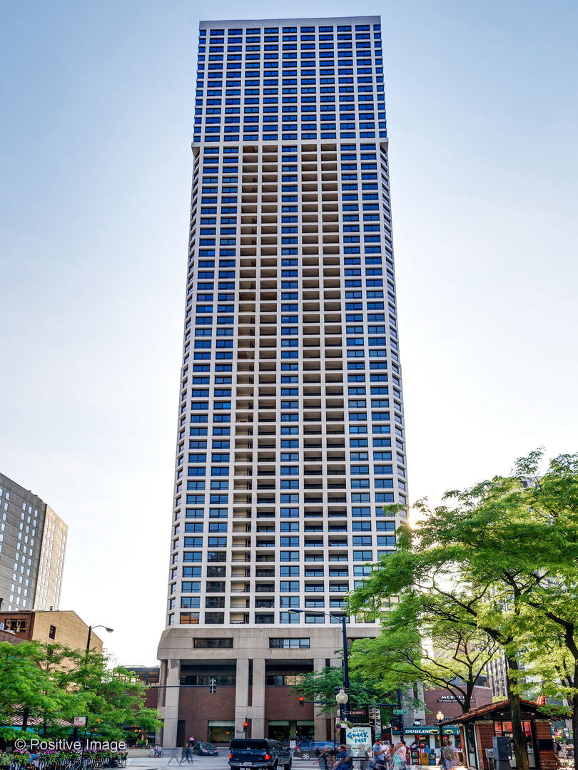 Bask in sunlight, sunsets, night lights, and city views from this southwest-facing 20th-floor corner two-bed, two-bath with private balcony in Newberry Plaza. Designed for style and comfort, this residence features over 50K in custom upgrades by Dan Rak, including bespoke drapery, layered window treatments, striking wall coverings, upgraded lighting, and a reimagined bathroom with new vanity, countertop, shelving, and hardware.    Step into an open-concept layout anchored by a white quartz waterfall island and Viking appliances. The split floor plan offers privacy, with king/queen-sized bedrooms and a versatile second bedroom for guests, a home office, or a gym. Wide-plank white oak floors, crown molding, custom closets, in-unit washer/dryer, beverage fridge, and marble baths with Kohler fixtures, rain shower, heated floors, and Toto toilet add a touch of everyday luxury.    Live in a full-amenity, professionally managed building with 24-hour door staff, outdoor pool, sundeck, fitness center, conference room, and on-site dry cleaning. HOA covers all utilities, plus high-def DirecTV and 250 Mbps high-speed internet. Leased parking available through SP+.    Located in the heart of the Gold Coast, you're steps from the lakefront, parks, farmers market, restaurants, entertainment, public transit, and multiple grocery stores.