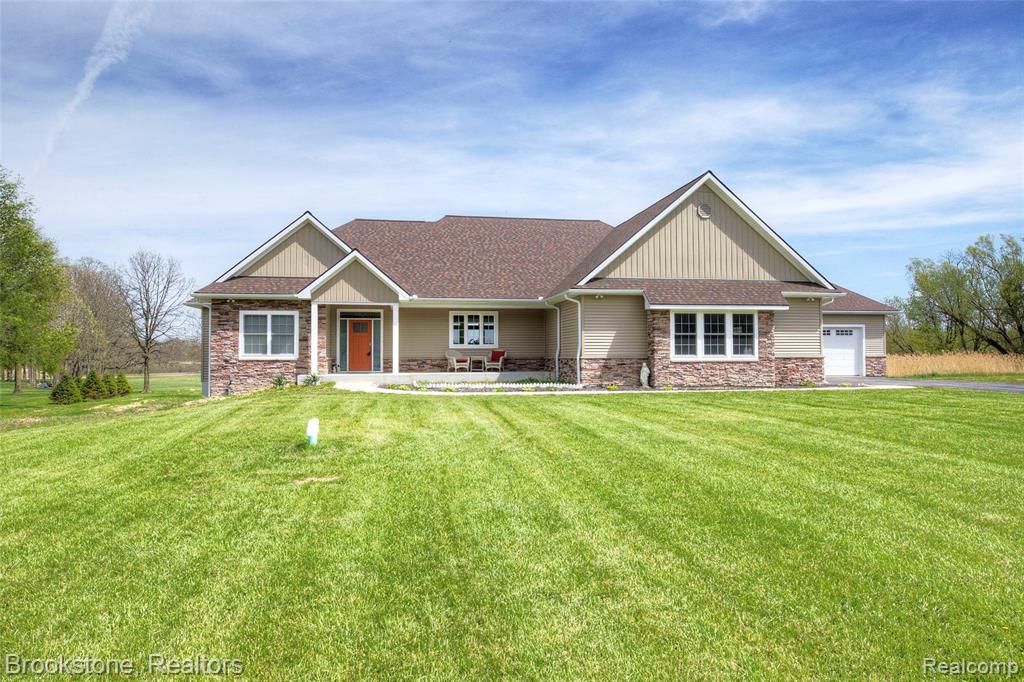 Custom-built in 2023 on 9.75 private acres with direct lake frontage, this exceptional property delivers space, flexibility, and quality rarely found in today's market. Set in an upscale neighborhood of large estate lots just one mile outside Downtown Lapeer, the home sits perched above a peaceful electric-only lake offering serene water views, exceptional wildlife, and year-round tranquility. The main level and upper floor offer 2 bedrooms plus a dedicated office, 3 full baths, and an open, light-filled layout designed for everyday living and effortless entertaining. Thoughtfully designed storage and finish work throughout reflect the 2023 build quality. Two oversized 2-car garages provide abundant space for vehicles, equipment, boats, and recreational gear — a rare find on a lakefront parcel. The fully finished walkout basement is purpose-built as a self-contained living quarters: 2 additional bedrooms, a private office, 1 full bath, and a complete second kitchen. Ideal for in-laws, extended family, multigenerational living, or long-term guests - all with private walkout access to the backyard and lake. The electric-motor-only lake ensures a quiet, unpolluted environment perfect for kayaking, fishing, and wildlife observation. Wake up to water views and spend evenings on the water in total peace.