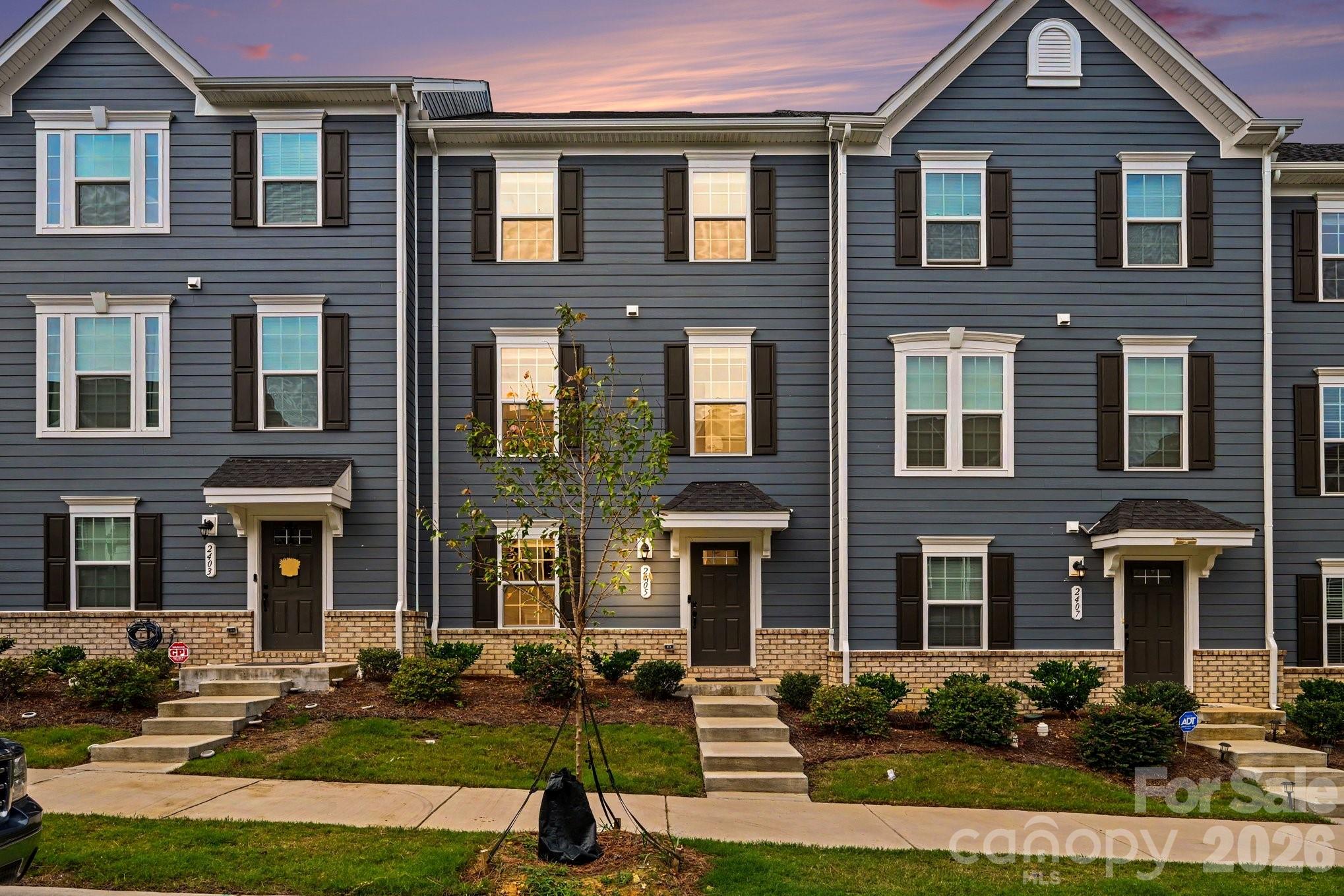 Welcome to 2405 Autumn Olive Lane, where modern style meets low-maintenance living! This beautiful 3-bedroom, 2.5-bath townhome offers a bright, open layout designed for both everyday comfort and entertaining.At the heart of the home is a spacious kitchen featuring crisp white cabinetry, sleek countertops, stainless steel appliances, a generous pantry, and an oversized island with plenty of space for seating and gathering. The kitchen flows seamlessly into the dining and living areas, creating an open and inviting main level filled with natural light. Step outside onto the private deck—the perfect spot for morning coffee, unwinding after a long day, or enjoying the outdoors.Upstairs, the spacious primary suite feels like a true retreat with a tray ceiling, abundant natural light, and an ensuite bath featuring a dual-sink vanity and tiled walk-in shower. Two additional bedrooms offer flexibility for guests, a home office, or whatever fits your lifestyle. Convenient upstairs laundry adds another thoughtful touch.A two-car garage provides plenty of room for parking and additional storage, while the home's neutral finishes make it truly move-in ready. Conveniently located near Matthews with easy access to shopping, dining, and the greater Charlotte area, 2405 Autumn Olive Lane delivers the space, style, and convenience you've been searching for.Don't miss your opportunity to make this beautiful townhome yours—schedule your showing today!