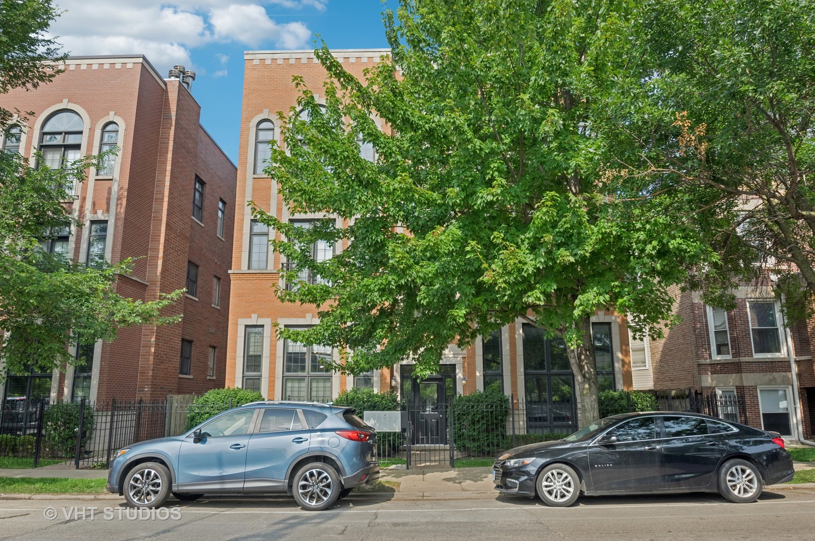 Introducing this beautifully updated 4 bedroom/ 3 bathroom duplex in an all-brick building, offering over 2500 sqft of living space in the heart of Avondale.  This sun-drenched, east-facing unit seamlessly blends classic charm with modern updates. The open-concept layout is perfect for everyday living and entertaining, featuring Brazilian cherry hardwood floors, detailed custom millwork and moldings, and a wood-burning fireplace that adds warmth and character.  The chef's kitchen features quartz countertops, new stainless steel appliances, a large island with bar seating, ample cabinet space, and a thoughtfully organized pantry.  The spacious primary suite, complete with a spa-like bath featuring a glass steam shower, soaking tub, and double vanity.  Step out onto your private patio for morning coffee or evening relaxation.  The expansive lower level offers a huge family room with great ceiling height, a custom-built Mendota gas fireplace, wet bar with beverage cooler and wine storage, new carpeting, and a large laundry room with full-size washer/dryer.  Additional highlights include organized closets with Elfa storage systems, one garage parking space included, an additional storage space, and a shared backyard and green space.  Just steps from Brands Park, top-rated restaurants such as Eden, Kuma's, Honey Butter Chicken, and Cafe Tola, shopping, the river trail, public transportation options, and easy access to the highway.  This home checks every box.  You won't want to miss this opportunity to own a move-in-ready gem in one of Chicago's most vibrant neighborhoods.  Schedule your tour today - this one won't last long.  Welcome Home.