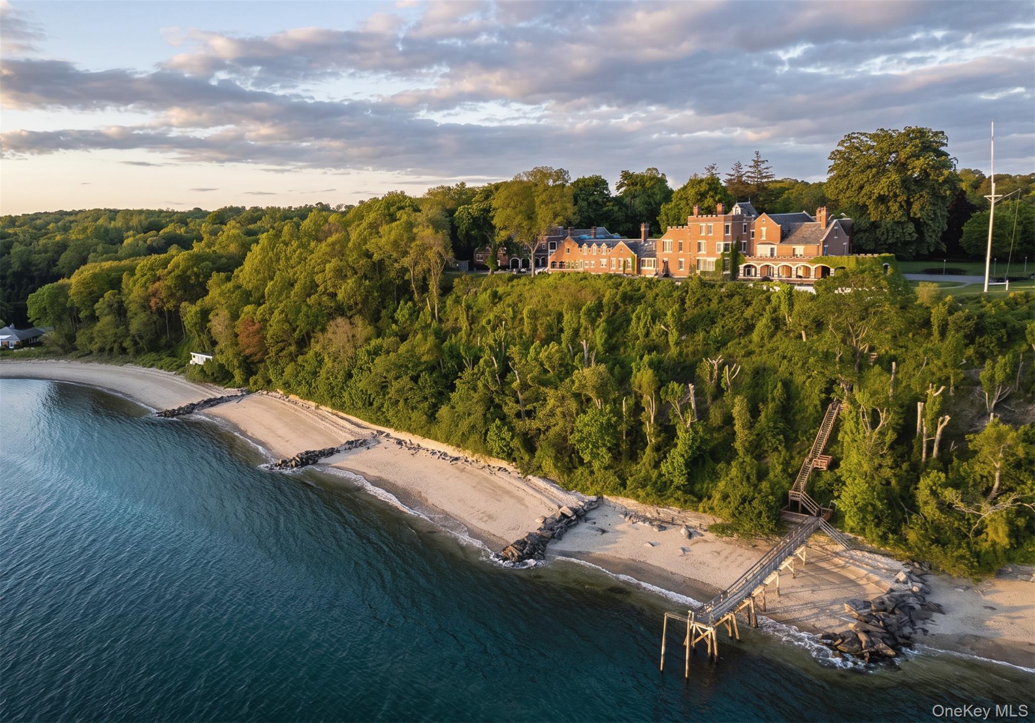 A Gold Coast Legacy Estate: Along the storied bluffs of Lloyd Harbor’s Gold Coast, where private drives wind through centuries-old trees and the water stretches endlessly toward the horizon, Fort Hill rises as one of the North Shore’s most iconic waterfront estates. Welcome to 31 Fort Hill Drive, 28,000 square feet of architectural gravitas set across 10 secluded acres, with 870 feet of private beachfront and a deep-water dock. From its elevated perch, panoramic views of the Long Island Sound unfold in every direction: sunrise mists, sailboats at golden hour, winter tides crashing below. The perspective is cinematic. The privacy absolute. Originally built in 1910 and masterfully restored to its original glory, this Victorian Revival masterpiece is both historic landmark and modern sanctuary. Thirteen bedrooms, ten full baths, and four half baths are artfully distributed throughout grandly scaled living spaces designed for legacy living and world-class entertaining. A luminous solarium captures the changing light of the Sound. A stately wood-paneled library offers quiet retreat. An exquisitely detailed ballroom: rare in scale and craftsmanship, stands ready for unforgettable evenings. Seven fireplaces, intricate millwork, and curated architectural detail evoke an era when homes were built not merely to inhabit, but to endure. The fully renovated gourmet kitchen anchors the residence with contemporary precision: integrating seamlessly into formal dining rooms and intimate gathering spaces. Staff quarters, a 16-car garage with guest apartment suites above, and flexible rooms for theater, wellness, or gallery use ensure the estate functions as effortlessly as it impresses. Outdoors, three acres of curated formal gardens and a greenhouse create a private botanical world: lush lawns, sweeping terraces, and moments of serene seclusion. A squash court, expansive grounds, and private shoreline complete a compound that is as rare as it is commanding. Set within moments to Huntington Village and the train to Manhattan, Fort Hill is not simply a home. It is a generational estate - where American history, architectural pedigree, and natural beauty converge. By appointment only.