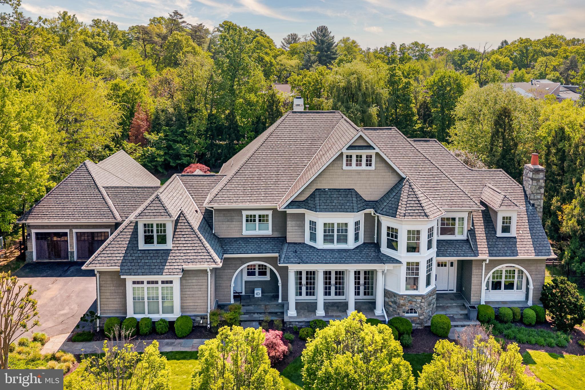 Designed by renowned architect Glenn Fong and built by Augustine Builders, this stone and shingle masterpiece is nestled on a lush .98-acre lot just 1.5 blocks from Potomac Village. Offering over 8,200 square feet of meticulously maintained and thoughtfully updated living space across 6 bedrooms, 7 full baths, and 3 half baths, this exceptional home is truly move-in ready. The extraordinary outdoor living spaces include a spectacular heated pool with waterfall and new pool skimmers, a pool house with summer kitchen, covered porch, and full bath — complete with replaced washer and dryer — plus a putting green, firepit, expansive patio, and screened porch. Upgraded gas fireplaces grace both the living room and outdoor entertaining areas. Inside, you'll find a gourmet kitchen with Sub-Zero and Viking appliances, refinished hardwood floors in white stain, and fresh paint throughout. The fabulous great room with 11" coffered ceilings, formal living and dining rooms, study, and expansive laundry/mud room with separate entrance complete the main level. The upper level showcases a dramatic primary suite with a fully updated spa-like bath featuring a new shower system and shower heads, dual walk-in closets, and enhanced insulation for superior climate control, plus four additional en-suite bedrooms — five en-suite bedrooms in total upstairs — with new ceiling fans throughout. The fully finished lower level offers a theater, home gym with natural light, wine cellar, guest bathroom, and an additional sixth bedroom with full bath.  A 4-car garage and soaring ceilings throughout complete this exceptional property.  An extraordinary offering in Potomac Village offering top rated schools, proximity to world class country clubs, and easy access to downtown Bethesda, I-495, and DC via River Road.