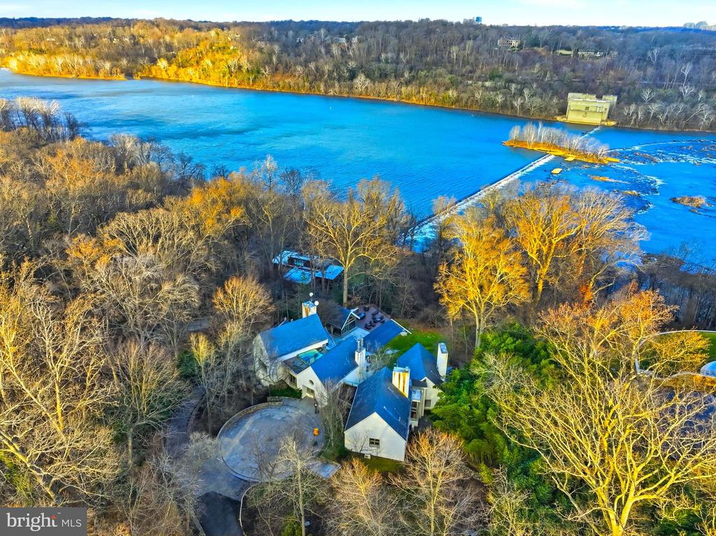 ***WATERFRONT ESTATE PERCHED ON THE GOLD COAST OF REVERED MCLEAN, VIRGINIA***This pinnacle estate CROWNS THE HILL WITH UNRIVALED VIEWS OF THE POTOMAC RIVER. SItuated across 3.64 ACRES of sculpted land in McLean where LEGACY MEETS LUXURY.***MASTER BEDROOM ON MAIN LEVEL***GLASS-BACKED ELEVATOR OFFERING SCENIC NATURE VIEWS***This breathtaking waterfront estate marries TIMELESS ARCHITECTURE with nature in the most beautiful way. OVER 8,000 SQUARE FEET of exquisitely crafted, light filled living spaces that feel both expansive and intimate.luxury finishes: master-crafted interior featuring FOUR FIREPLACES, AND A GOURMET KITCHEN AND YOUR OWN GLAM HAIRCUTTING NOOK–COMPLETE WITH PRO CHAIR AND MIRROR. Gracious formal rooms and SOARING WINDOWS THAT FRAME SWEEPING RIVER VISTAS AT EVERY TURN. Outdoors, the property unfolds into manicured lawns and terraces that lead to a show-stopping, RESORT-CALIBER INFINITY-EDGE POOL blending seamlessly with the Potomac, complemented by STATE‑OF‑THE‑ART WHISPER QUIET POOL HOUSE BOASTING A PRIVATE GYM WITH A CHANGING ROOM, SHOWER, WINE CELLAR, GUEST SUITE—perfect for your morning laps or lifting sessions without leaving your residence. total of 7BR, 7 TOTAL BA (6BA AND 2 HB). Includes HEATED 3 CAR GARAGE and central vacuum. Also, the garage has extra storage room and its own extra washer/dryer. This breathtaking home has SELECTED LIMESTONE, CHERRY WOOD, GRANITE AND MAPLE. Step through and let the VISIONARY FLOOR PLAN pull you into spaces that feel refreshed, new—like nothing you’ve stepped into before. RIVER VIEWS SEEM TO GO ON FOREVER, creating a serene backdrop from dawn to dusk and giving the home a RARE SENSE OF PRIVACY AND ESCAPE WHILE STILL HAVING SWIFT ACCESS TO THE WORLD‑CLASS SHOPPING AND DINING OF TYSONS CORNER CENTER AND TYSONS GALLERIA, AS WELL AS MAJOR COMMUTER ROUTES AND A FEW MILES TO DOWNTOWN WASHINGTON, D.C., CULTURAL LANDMARKS ETC… Live the unparalleled lifestyle along one of the Capital Region’s most exclusive stretches of riverfront. THE LISTING ENCOMPASSES BOTH 1100 AND 1153 CREST LANE THAT ARE 2 LOTS CONSOLIDATED INTO A TOTAL OF 3.64 ACRES OF PRIME RIVERFRONT GRANDEUR.  Please note, showing is by  appointment with 24 hour notice. The following link with show use videos, floor plans, Virtual Tours and more: https://view.spiro.media/1100_crest_ln-778https://view.spiro.media/1100_crest_ln-778