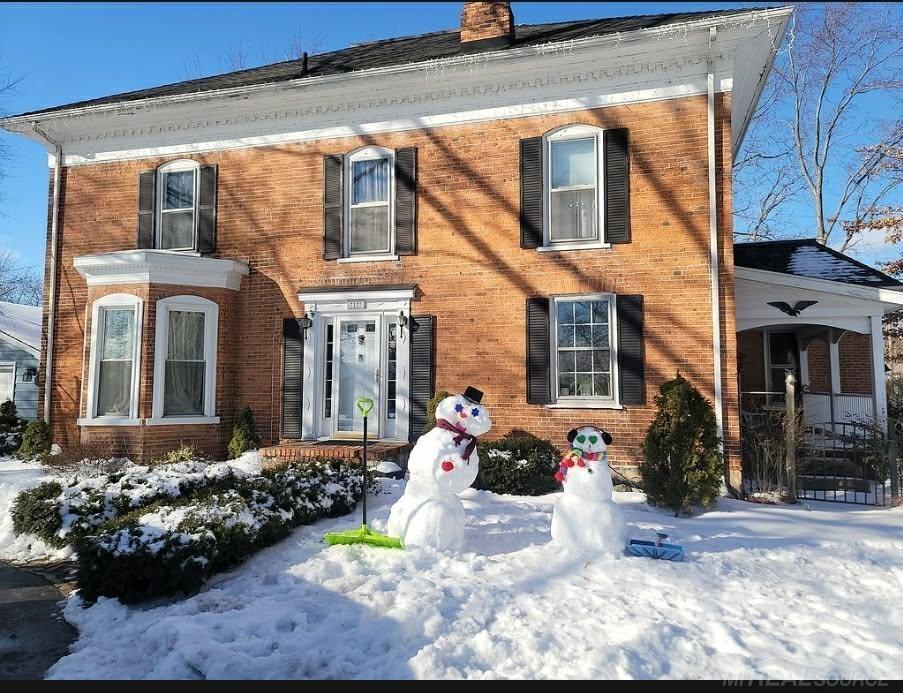 HISTORIC FEDERAL-STYLE BRICK HOME IN THE VILLAGE - Spacious 2800+ sq ft home with tons of possibilities. 5/6 Bedrooms, 3 baths, LR with built in bookcase, wet bar and window seat, formal dining room, den/family room, plank and hardwood floors and original touches throughout. Lovely covered porch on the south, deck on the North side. Beautifully landscaped fenced yard. Over sized garage. Access to Lake Huron at the end of Lake Street.  No Sign on property