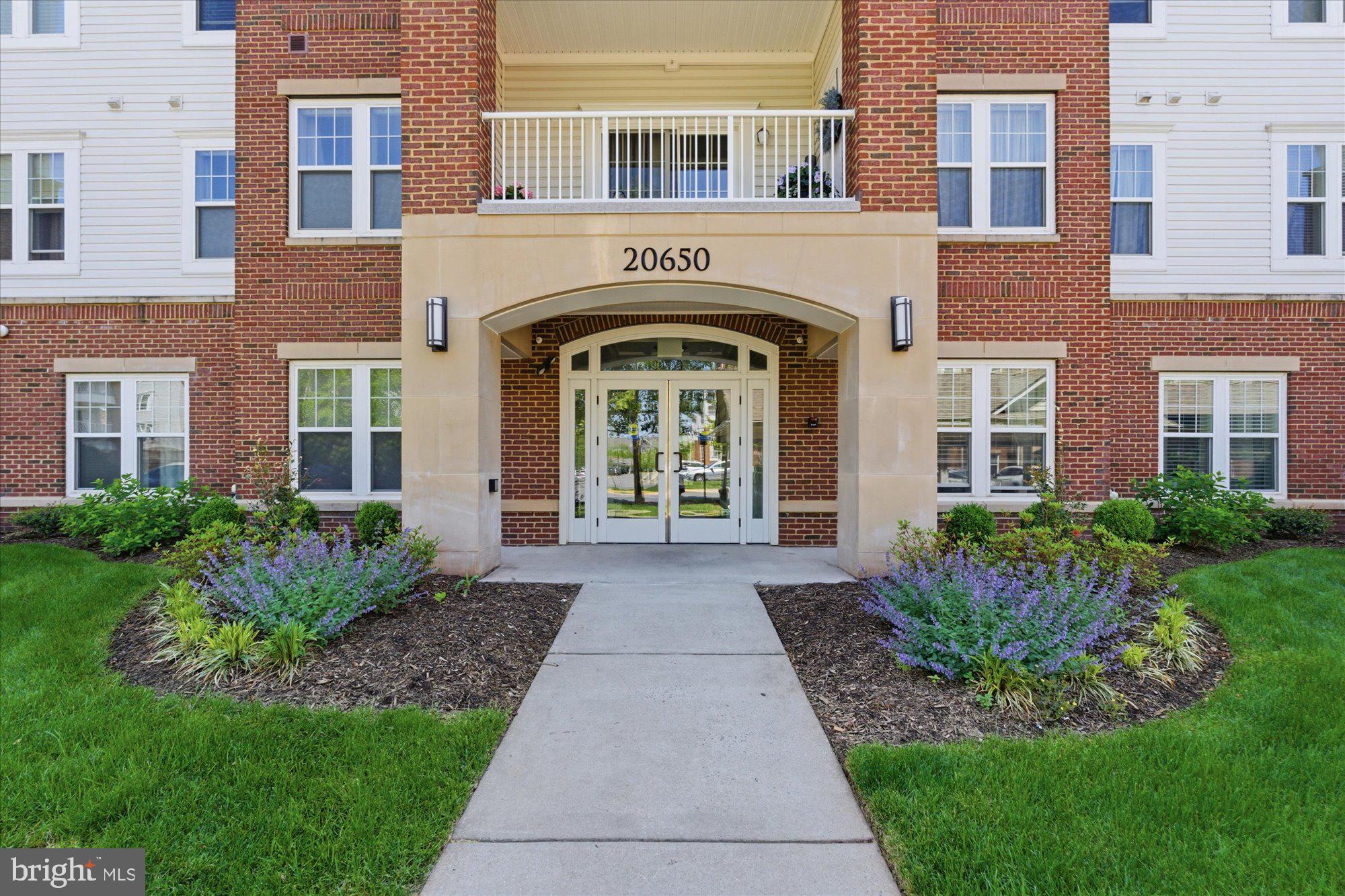 Welcome to the Davenport model in Potomac Green — widely regarded as one of Northern Virginia’s premier 55+ communities. This beautifully upgraded 2-bedroom, 2-bath condo with a separate den offers an inviting open floor plan and stylish finishes throughout, including upgraded kitchen and bath cabinetry, hardwood flooring, granite countertops, designer tile, and stainless steel appliances. Two stunning designer chandeliers add elegance and character to the living and dining space, while new carpet in the bedrooms and fresh paint throughout make this home truly move-in ready. Enjoy a private balcony, garage parking with inside access, and an additional storage unit for added convenience.Potomac Green delivers a resort-style lifestyle unlike any other. Residents enjoy a stunning clubhouse featuring a fitness center, yoga and exercise studio, heated indoor pool with lap lanes and water aerobics, hot tub, outdoor pool, card and game rooms, billiards, lounge areas, lending library, ping pong, computers, and an indoor walking track. Outdoors, enjoy tennis and pickleball courts, bocce ball courts, garden plots, scenic walking and jogging trails, and preserved wetlands with paths leading directly toward One Loudoun.Ideally located just minutes from shopping, dining, wineries, golf courses, the W&OD Trail, INOVA Loudoun Hospital, Dulles Airport, and Washington, DC, Potomac Green also offers easy access to transit, parks, a nearby sports complex, dog park, and Loudoun County Senior Center. This is more than a home — it’s a vibrant lifestyle and community.