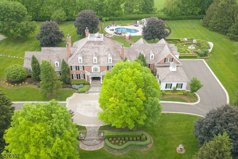 Once in a lifetime opportunity to live the Dream, impeccable ALL BRICK GEORGIAN COLONIAL ESTATE sits on 5 totally level acres surrounded by mature trees with extensive landscaping for extraordinary privacy. Built in 1991 on a quiet street in bucolic Mendham Township, the property has had over 3 million dollars in additions, replacements + renovations by the current owners.  There is nearly 13,000 square feet of interior space with incredible amenities including stunning pool + pool house, tennis court, climate controlled barn, golf simulator, home theatre, 600 sq ft home gym; sauna, 900 bottle cherry wine cellar +  game room. The house has high ceilings, custom cabinetry, 5 fireplaces, 6 bedrooms with 2 Luxurious Primary Suites, one on the first floor, two offices, 2 laundry rooms + easy 1st floor access to 5 car attached garage new in 2016. Creston automation, LED lighting and Fine Art Lamps handcrafted throughout the house. Outdoors the gated property features a level yard, garden, fountain, a 30 KW generator, summer kitchen, fire pit and electric dog fencing. Your dream home suited for multi generational living. Can be sold fully furnished. US News & World Report ranked Mendham Middle & Elementary Schools 3rd & 4th in New Jersey respectively.