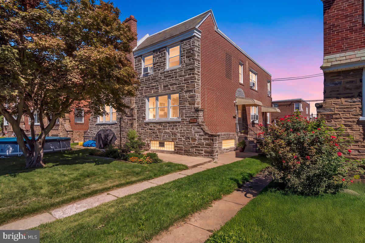 Welcome home to this meticulously maintained 3-bedroom, 2 bathroom stone-front twin, ideally situated on a quiet street in the highly desirable Sandyford Park section of Northeast Philadelphia. Lovingly cared for by the owner, this exceptional home reflects true pride of ownership from top to bottom. From the moment you arrive, you’ll appreciate the beautiful curb appeal featuring tasteful landscaping, an attractive all-stone front exterior which has been newly pointed, private front patio, and 3 oversized windows that fills the home with natural light. Step inside and immediately notice the gorgeous, premium hardwood flooring that carries t/o the entire home.  The bright and spacious living room is highlighted by the oversized windows, stunning hardwoods, and newly painted bright white walls. The formal dining room offers plenty of space for family gatherings and entertaining, custom chandelier, and a generous coat closet. The spacious eat-in kitchen features abundant cabinetry, plenty of countertop space, recessed lighting, built-in appliances, and direct access to the side yard and back driveway. Upstairs, you’ll find a generously sized primary bedroom with his-and-her closets, fresh paint and ceiling fan light fixture.  The timeless hall bathroom features ceramic tile, a soaking tub, and a separate glass-enclosed stall shower. Two additional bedrooms are both nicely sized and offer ample closet space, ceiling fan/light fixtures, and fresh paint. The oversized finished lower level provides an impressive amount of additional living space and offers tremendous flexibility as a family room, playroom, home office, or possible fourth bedroom. Features include recessed lighting, ceramic tile flooring, a full bathroom with stall shower, multiple storage closets, expanded front and side glass block windows. This level also includes a separate laundry area with all the amenities, inside access to the garage one car garage, and access to the driveway that provides private parking. Conveniently located near major highways, public transportation, schools, shopping, and dining, with neighborhood food markets within walking distance. Impeccably maintained inside and out, this wonderful Sandyford Park home has been cared for with pride over the years and it clearly shows. A truly special property that is ready to welcome its next owner!