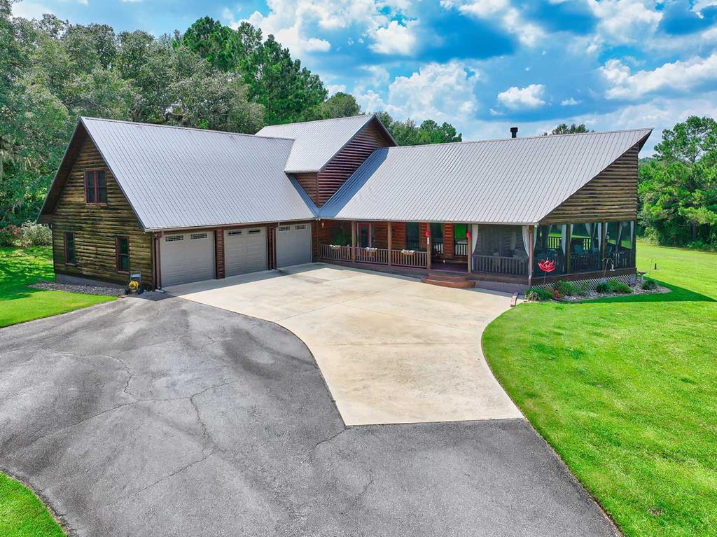 Welcome to The Townsend Farm—a rare slice of South Georgia where mornings begin with the sound of quail calling, quiet wide-open views, and days shaped by land, freedom, and possibility. Set across 47 scenic acres, this one-of-a-kind property is nestled among Thomasville's most pristine properties and located in the famed Red Hills Region of Thomas County, offering the kind of privacy and natural beauty that's increasingly hard to find.    The land features a beautiful mix of open, income-producing farmland and long-leaf pine with wiregrass, creating a versatile setting ideal for an outdoorsman, private retreat, or working property. At the center of the farm sits a custom-built cypress log home offering nearly 3,500 square feet of comfortable living space.    The main level includes the primary suite, a flexible bonus room ideal for a bedroom, office, or hobby space, a half bath, and inviting living areas centered around a fireplace. One of the home's most loved features is the spacious screened-in porch, often referred to as the “outdoor living room,” perfect for relaxing and taking in the peaceful surroundings.    Upstairs, you'll find two additional bedrooms, a full bath, and a bonus room, providing plenty of space for family or guests. The home also offers abundant storage throughout. Convenient to Tallahassee.