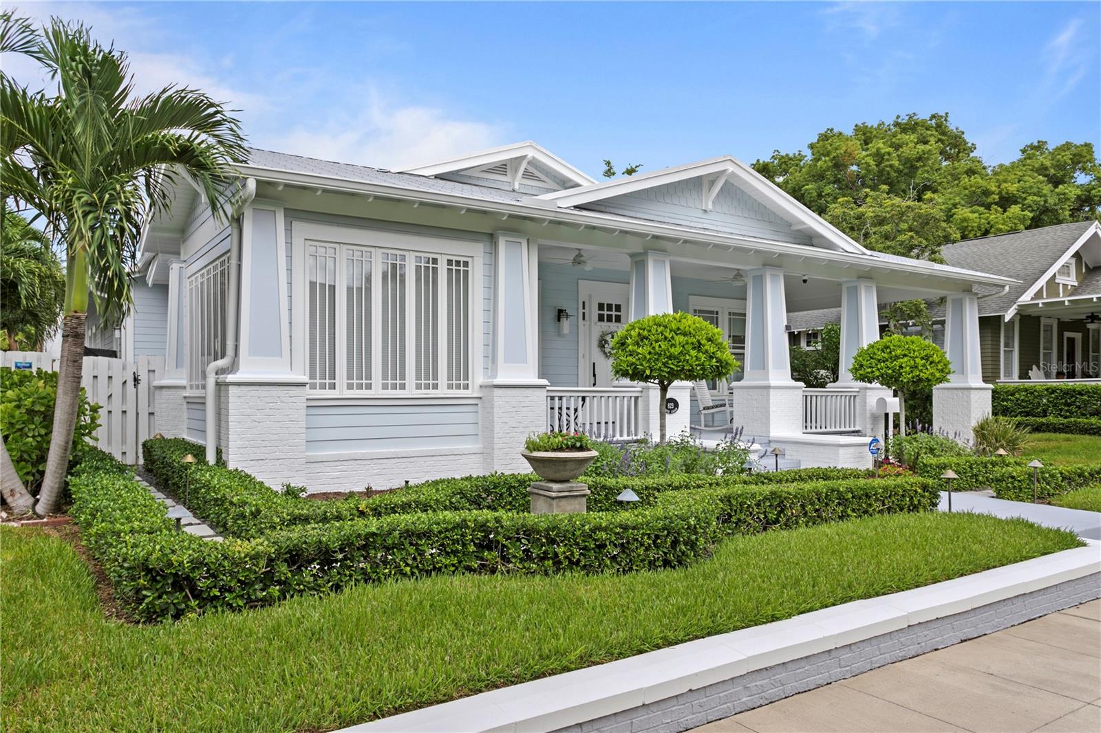 Welcome to Hyde Park's Golden Triangle where this rare one story home was designed and built to resemble the historic homes of Hyde Park but was completed in just 2005. Construction is concrete block with hardie board siding and brick. The 3 bedroom 3 1/2 bath main house has a porte-cochere for easy covered access.  Rich 8 inch wide oak planked floors are throughout and add to open floor plan. A sunroom in the front of the house offers bay views and can be used as a den or office. The large dining room has custom built-ins. JennAir Noir appliances, including induction cooktop, convection oven and wine cooler can be found in the kitchen accented by white marble counter tops. The kitchen peninsula opens to the great room, with box beam ceiling, custom built-ins, and gas fireplace. French doors lead to the back porch complete with an outdoor kitchen, with grill hood. The primary bedroom has a walk-in closet, and the primary bath has a large walk-in shower. All three bedrooms are en-suite. The property also includes a Carriage House with two car garage, both front and alley entrances. The Carriage House guest suite is its own private oasis, with vaulted wood ceilings, complete breakfast bar area, wonderful natural light and a Mitsubishi split system. The Galvalume 5 V crimp metal roof was installed in 2021. And the Navien tankless gas hot water system for the main house in 2024. The pool was resurfaced in 2021 as well as new marble pavers installed. Close to the restaurants and shops of Hyde Park Village and just steps from Bayshore Boulevard, this home offers the rarity of living in Tampa’s premier Historic district but in a currently built one story home.