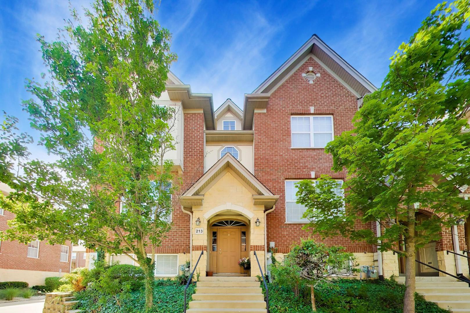Thoughtfully updated, this end-unit Riverwalk Hamilton townhouse offers an exceptional layout with abundant natural light from desirable southern exposures and soaring 9-foot ceilings. The raised main level features beautiful hardwood floors that flow seamlessly from the spacious living and dining areas into the open-concept kitchen, adjoining family room, and convenient powder room.  Designed with both everyday living and entertaining in mind, the kitchen showcases a center island with bar seating and pendant lighting, freshly painted upper and lower cabinetry, a stylish new backsplash, granite countertops, stainless steel appliances, and recessed lighting. The adjacent family room provides a warm, inviting gathering space with direct access to a private balcony.  Upstairs, you'll find three generously sized bedrooms, two full bathrooms, and a conveniently located laundry closet. The primary suite features hardwood floors, a spacious walk-in closet, and an ensuite bath complete with a double vanity, walk-in shower, and jacuzzi tub.  The finished lower level offers a versatile recreation room that can easily serve as a home office or fitness space, along with a dedicated storage room and direct access to the attached two-car garage.  Ideally situated in a highly convenient location, this home is just minutes from shopping, dining, major expressways, public transportation, O'Hare International Airport, and is located within the highly regarded Hersey High School District.
