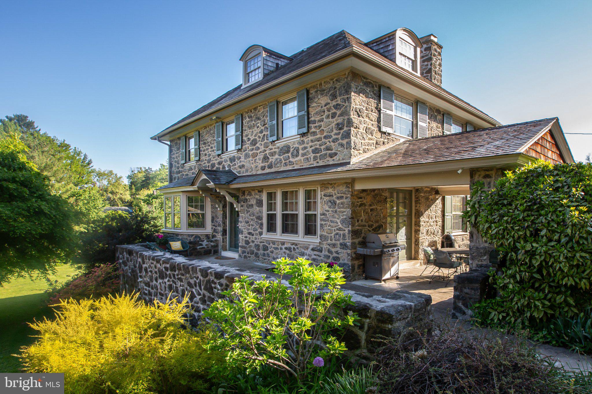 Welcome to 124 N Highland Avenue, a distinguished 5 bedroom, 4.5 bathroom stone home in the sought-after community of Bala Cynwyd. Built in 1925 and thoughtfully updated over the years, this home blends timeless Main Line character with the space and comfort desired for modern living. Set back on a long, private driveway with mature landscaping, the welcoming front porch leads to a spacious foyer, bright living room with fireplace and access to a partially covered front patio, formal dining room, and inviting kitchen featuring cherry cabinetry, granite countertops, stainless steel appliances, hardwood floors, and a six-burner stove. The spacious primary suite offers a walk-in closet and beautifully appointed private bath with limestone floors and a generous steam shower, while a convenient second-floor laundry adds everyday ease. A finished lower level provides a large recreation or playroom, separate finished space with a full bath and Murphy bed, and potential for an in-law or guest suite, with additional unfinished space for storage and mechanicals. Traditional architectural details, abundant natural light, and an expansive rear yard add to the home’s appeal. Located in the award-winning Lower Merion School District and within easy reach of parks, shopping, dining, the Bala Cynwyd Library, and Cynwyd train station, with convenient access to Center City Philadelphia, 124 N Highland Avenue offers a wonderful combination of character, comfort, privacy, and location.A long driveway leads to the home, with tall bushes along the front providing a sense of privacy and seclusion. The stately stone exterior and welcoming front porch create an inviting first impression. Inside, hardwood floors and abundant natural light complement the home’s traditional character. The spacious front living room features a fireplace and opens onto a partially covered front patio, while the dining room provides a comfortable setting for everyday meals and entertaining. The well-spaced kitchen offers cherry cabinetry, granite countertops, stainless steel appliances, and a six-burner stove.Upstairs, the primary bedroom features a walk-in closet and private full bathroom, while a convenient hallway laundry area includes a washer and dryer. Additional bedrooms offer flexibility for family, guests, or home office use, with a hallway bathroom serving the second floor. The third floor provides another bedroom, a full hallway bathroom, and additional storage, along with a versatile space that could serve a variety of needs.The finished lower level is a particularly versatile feature of the home. At ground level, this expansive area includes a large recreation or playroom, along with a separate finished space featuring a full bathroom and Murphy bed. With its private access to the driveway and generous finished space, the lower level offers excellent potential for an in-law arrangement, guest suite, home office, gym, or additional living space. The unfinished portion provides useful storage and convenient access to the home’s mechanical systems.Outside, the expansive rear yard offers plenty of room for outdoor enjoyment, gardening, play, and entertaining. The combination of the private setting, generous interior spaces, finished lower level, and classic stone construction makes this a unique opportunity in Bala Cynwyd.Located in the award-winning Lower Merion School District and convenient to parks, shopping, dining, the Bala Cynwyd Library, Cynwyd train station, and Center City Philadelphia, 124 N Highland Avenue offers the space, character, privacy, and location today’s buyers are seeking.