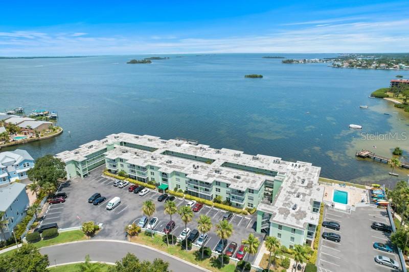 WOW--DIRECT WATERFRONT BUILDING!  Rare 2BED/2BATH split plan with SCREENED BALCONY in desirable Dolphin Pointe on Dunedin Cswy that's FULLY RENOVATED PLUS TASTEFUL FURNISHINGS INCLUDED! TOP FLOOR TURNKEY UNIT with new CONCRETE ROOF sustained NO HURRICANE DAMAGE OR FLOODING and has NEW cabinets & vanities, GRANITE tops, STAINLESS appliances, ceiling fans, custom lighting, LUXURY VINYL floors in living/dining/bedroom areas.  This popular building near FRENCHY'S boasts LOWER MAINTENANCE FEES, 30-DAY MINIMUM RENTALS, HEATED pool, fishing pier, waterfront BBQ GAZEBO & library/game room, KAYAK storage & w/launch area, bicycle storage etc. LOCATION doesn't get better than this: DUNEDIN CSWY with Drum Circle Mon & Thur, PINELLAS TRAIL, HONEYMOON & #1-rated CALADESI ISLANDS plus eclectic downtown Dunedin all nearby. It's a SHORT WALK to restaurants, shopping, pharmacy, bank, bus & more. All ages welcome & one indoor cat for Owners only. Live full-time where others vacation or use part-time & make RENTAL INCOME remainder of time. All ages welcome.  A Milestone Report is completed with NO SPECIAL ASSESSMENTS.  ACT FAST OR YOU'LL MISS OUT!