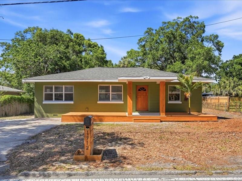 One or more photo(s) has been virtually staged. Welcome to 1912 E Hanna Ave, a rare opportunity to own a fully reimagined Seminole Heights home on an oversized lot that stands out from the rest. Situated on an impressive 72 x 140 lot, this property offers substantially more land than the typical 50 x 100 lot, creating room to expand, entertain, add a pool, build an ADU, or simply enjoy the privacy and space that is becoming harder to find in Tampa.From the moment you arrive, the olive-green exterior, warm wood deck, and matching door tell you this isn’t your average home.Inside, luxury vinyl flooring flows through every room, and the open layout breathes with natural light and intentional design.The cozy kitchen delivers shaker cabinets, stainless GE appliances, a gorgeous sage green subway tile backsplash, and a dedicated coffee/wet bar with built-in mini fridge.The bathroom, is a complete showstopper. emerald green tile, dual matte vessel sinks on a floating wood vanity, and a pair of backlit LED mirrors that makes you feel like you’re living somewhere that costs twice as much.Located minutes from downtown Tampa, Ybor City, Armature Works, and major highways, this home combines style, substance, and land value in one compelling package.Move quickly. Homes with this level of renovation and this size lot are rare. 1912 E Hanna Ave is the kind of property buyers regret missing.