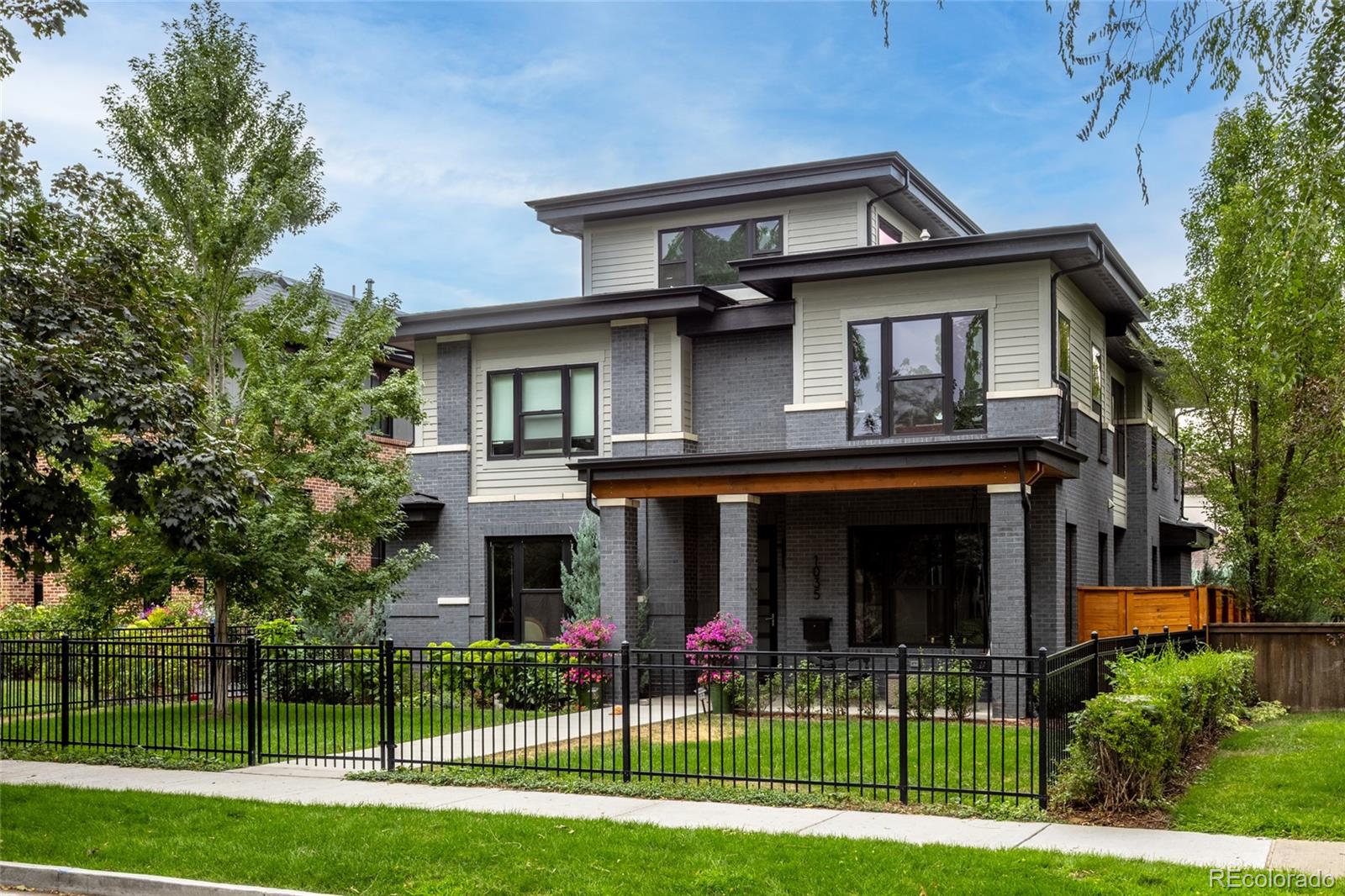 2021 Devex-built, 5,442-square-foot classic-contemporary residence in the heart of Denver’s highly coveted Bonnie Brae neighborhood. This exceptional 5-bedroom, 5-bath home combines sophisticated architecture, extraordinary indoor-outdoor living, and a walkable location just over two blocks from Bonnie Brae Ice Cream, three blocks from the shops and restaurants of Old South Gaylord, and seven blocks from Washington Park.The heart of the home is an expansive main living area designed to function as the true gathering space, bathed in natural light. Two outdoor spaces, one covered and a lush landscaped backyard are accessed by opposing retractable glass walls. The result is a rare indoor/outdoor/indoor living experience that effectively triples the entertaining footprint of the main level. Upstairs find the Primary bedroom with a 12x14 walk-in closet, two en-suite bedrooms and two bonus rooms. The rooftop deck features mountain views from an expansive roof top deck. The basement has high ceilings two additional bedrooms and a huge rec room.