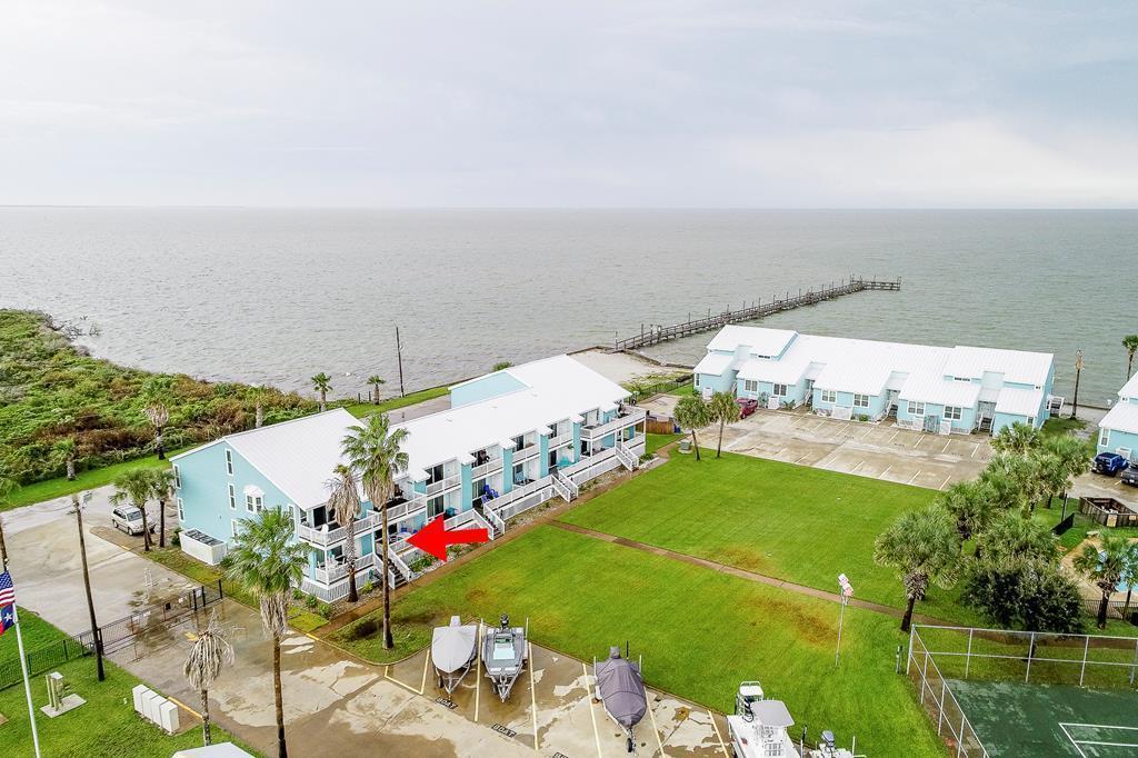 Charming condo featuring fabulous water views on one side and a view of the sparkling pool on the opposite side!  This spacious 1 bedroom, 1 bath condo is located in the desirable Bayfront at Kontiki Condominiums and has everything you need!  Open floor plan, a large owner's suite, tile tub surround, a tankless water heater, and wood look tile flooring complete the beautiful condo.  As an added bonus, there is a set of built in bunk beds for extra guests.  The back deck has a wonderful canal view and is a great place to unwind and watch the sunset after a day on the water.  The scenic surroundings make this the perfect vacation rental or permanent home.  Amenities include a swimming pool, a bay front pier, a boat ramp, boat parking, a tennis court, and covered grilling areas.  Short and long term rentals are allowed if you are looking for an investment property.  The unit comes mostly furnished.  Call your favorite Realtor today and come see this fabulous property for yourself!