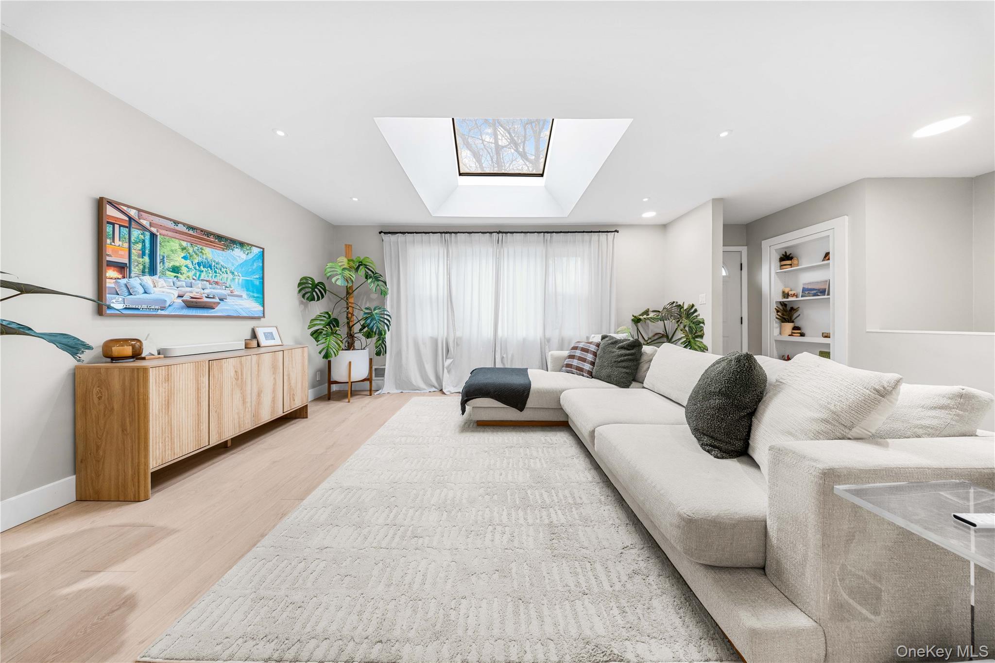 A rare opportunity to own privacy in NYC, a fully renovated 40x100' detached corner ranch just 10 minutes from the heart of Astoria and the heart of Jackson Heights with incredible commuter & driving accessibility. (10 min to Ditmars/Steinway,10 min to 73rd St/Roosevelt)From the moment you step inside, natural light pours in through multiple exposures,including a skylight, with unobstructed views from the North,East,and West sides of the home, wrapping it in warmth throughout the day.The open layout flows effortlessly with modernized definition,creating a space that feels both airy and purposeful.The living area transitions seamlessly into the dining space, opening to a redefined lower level, ideal for entertaining or simply enjoying everyday life.The kitchen has been tastefully updated with herringbone marbled tiling, a built-in dishwasher, and plentiful cabinetry.Wide planked flooring and spotlighting installed throughout the home gives a Scandinavian inspired finish, blending functionality with style throughout. All bedrooms are generously sized including the master suite currently with a Californian king sized bed frame, offering comfort and quiet retreat, while two updated bathrooms reflect beautiful aesthetics.The true magic of this home is how it feels. Living with surrounded space, a true back yard, front yard and side yard. A calm brightness from every angle that only a corner property can provide, and a central location providing an added unique benefit only found in this precise location.This completely renovated detached one-family home is located on the popular and quaint, 73rd Street, neighboring Astoria, Jackson Heights and Woodside. Known for its tree-lined street among yarded, similar detatched single family homes, the area offers space, stability and long-term value. It's rare a house on this block becomes available. It sits proudly on its oversized corner lot, offering a rare suburban presence just minutes from everything. It's a 10 minute commute, 20 minute walk to a major train station offering the E, F, M, R and 7 trains into the city-a short 20 minutes into midtown Manhattan and 30 minutes to downtown Wall Street where the current residence work.Outside, the oversized lot creates possibilities that are increasingly hard to find in Queens. A large one-car garage and private driveway add everyday convenience, while the expansive outdoor space offers room to entertain, garden, expand,or simply enjoy open sky. It genuinely delivers a suburban lifestyle while remaining in New York City. For the visionary buyer, the opportunity extends beyond what exists today. With R3 permits allowing the potential to build approximately 3,400 square feet, the property presents the possibility of creating a substantial two-family residence in a location where demand continues to remain strong. Whether you choose to enjoy it exactly as it is or elevate it into something even grander, the foundation is already here. As a bonus, the thoughtfully designed renovation delivers smart home integration features, adding to its convenience, lighting controlled by AI assistance. Nest home installation to control an updated forced air HVAC system, as well as remote door locking/unlocking capabilities. Mechanicals within relatively new, and well-maintained, with a brand new Water Heater installed, as well as an EV charger outlet installed in the driveway for electric car charging convenience.Located just 1 block from the Prestigious Monsignor McClancy High School, ranked #37 Best Catholic High School in New York with a Grade A rating from Niche.Residents will also benefit from convenient access, under 5 minutes from the Grand Central Parkway and Brooklyn Queens Expressway, and an 8 min drive to and from LaGuardia Airport,with ease of commuting to Long Island, Manhattan, Westchester Country and New Jersey(a 25 min drive to Fort Lee on weekend mornings). This is not just a home, it's a position of value and comfort.