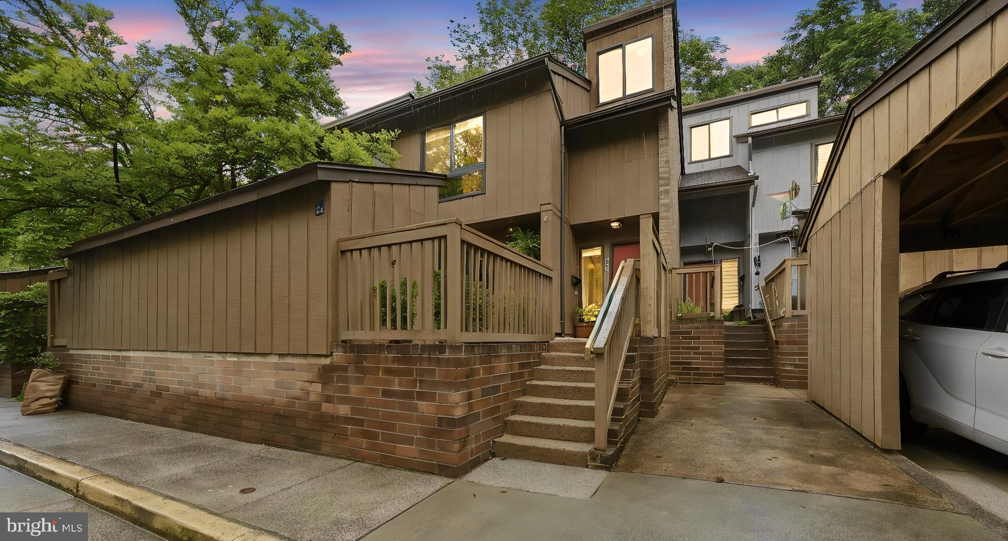 Located in the serene Colts Neck community, this contemporary-style townhome delivers something increasingly rare: the energy and convenience of city living without ever losing sight of the trees. From the moment you step inside, the design intention is clear. Large tile in the foyer and kitchen, granite counters, stainless steel appliances, and an exposed brick accent wall strike a confident balance between modern renovation and mid-century character. The open main level, where a wall was thoughtfully removed to connect the kitchen and dining areas, is filled with natural light and anchored by the custom fireplace. Dark-stained hardwood floors, a floating staircase, and a neutral palette give the space a polished, cohesive feel throughout. A powder room and two sliding glass doors off the front and back make it easy to enjoy outside, whether that's hosting dinner al fresco, enjoying a quiet morning with coffee, or simply letting the outdoors in. Upstairs, the primary suite impresses with floor-to-ceiling windows, vaulted ceilings, a renovated ensuite bath, and a custom walk-in closet. Two additional bedrooms with generous closet space, a full hall bath, and a fully renovated laundry room with washer, steam dryer, utility sink, cabinetry, and dedicated flooring round out the first upper level. On the third floor, a versatile loft with a doored entry and extra storage closets is ready to become your home office, creative studio, media room, or guest retreat. Recent updates: new dishwasher (2026), water heater (2025), front landscaping (2025), and a stone sitting wall added to the backyard (2023), on top of an already impressive list of prior renovations, including the roof, front deck, front slider, washer/dryer (2019), windows (2018), and HVAC (2015). Outside, a covered parking space sits just steps from your front door, and a powered shed offers flexible workshop or storage space. Then there's the neighborhood itself. With 55 miles of trails, 1,350 acres of open space, 15 pools, and 52 tennis courts through the Reston Association. Reston Town Center, Dulles Toll Road, and metro are all just minutes away. You'll spend less time in the car and more time enjoying everything this home and its surroundings have to offer. This is a home that gives you the best of both worlds every single day. The city when you want it, nature when you need it.