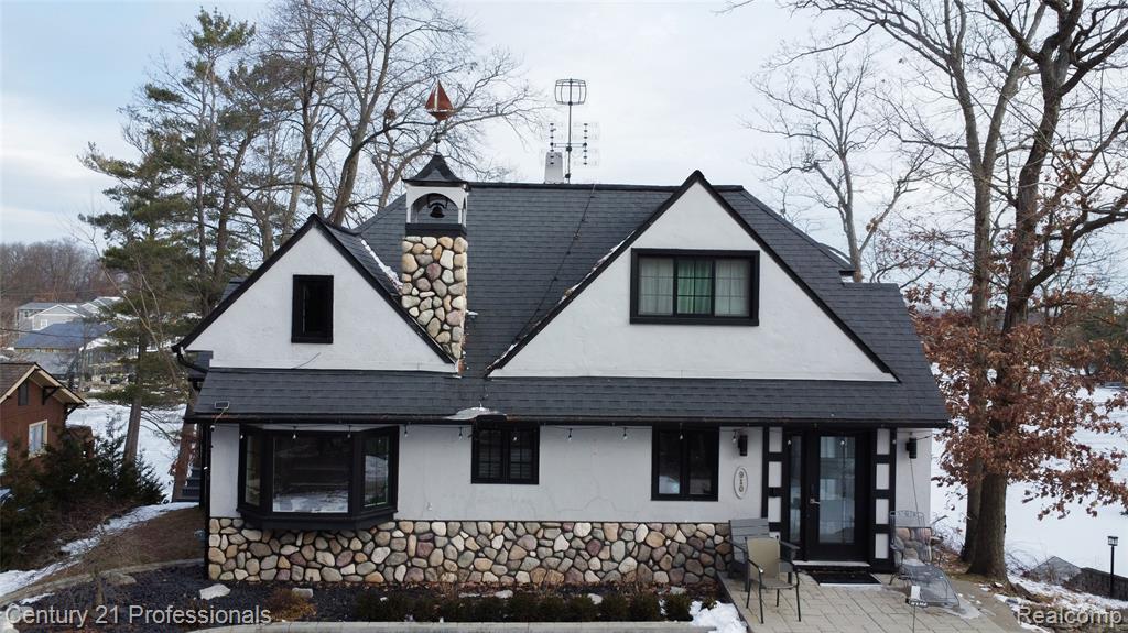 Beautifully sloping property with expansive waterfront views and over 80 feet of frontage on all-sports Lake Orion. The home’s unique design offers versatility and cozy charm, making it ideal for a variety of living arrangements. The main residence features an efficient layout with two bedrooms and three full bathrooms.A separate loft-style living quarters above the spacious three-car garage provides exceptional space for guests, extended family, or older children. This home has been continuously remodeled and showcases a new gourmet chef’s kitchen complete with high-end stainless steel appliances. Major mechanical updates include newer boilers, instant hot water, Andersen windows, and refreshed landscaping.Relax by the fireplace in the living room, unwind in the heated-floor sunroom, or dine in the breakfast nook; each offering stunning lake views and access to the deck overlooking the water. The lower-level primary suite features a private bathroom and direct access to the lake, creating a true waterfront retreat.