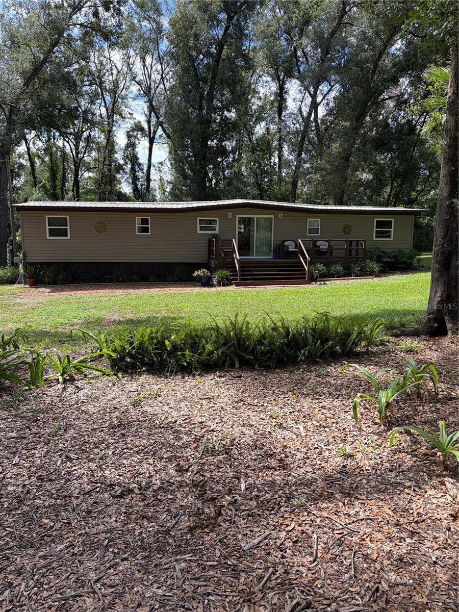 Beautiful 2.5 acres, plenty of mature trees and  lovely landscaped in Brooksville, Florida.  I-75 is nearby 4 miles west and Cortez Bvld (State road 50).  Private road from Mondon Hill Road, very nice area.  Located at the end of the road, so no extra homes can be built next or near to you.  In 2023,  35 trees were removed and stump grinded,  so a nice vegetable garden could be grown.  Totally renovated home 2024 - 2026,  new metal roof,  2 bedrooms, 2 bathrooms,  country feel and design in each room, all appliances purchased in 2024 - 2026 to include oven/stove, washer, dryer, refrigerator with freezer and ice maker, additional freezer in outside storage, wooden kitchen cabinets with some butcher block counter, 2 mini split ac/heat electric units purchased and installed 6/2024,  and new 2026 mini split added, hot water heater is electric and on demand 2 years old.   New windows, new doors throughtout, new drywall, insulation, new plumbing and electric as well.  The flooring is pressure treated 3/4 inch pressure treated plywood with new insullation and underlayment and vinyl wood planking on top.  There is a new and  above ground pool, filter, chlorinator, skimmer and plenty of privacy.  Extra large front porch size 18' x 6'  and back porch 28' x 8' to enjoy the wildlife, views of nature or a cup of coffee. Two large fire pits to keep you warm on a chilly night.   Home warranty for one year.  Property insurance $836 October 25-26.  There is a generator and electrical hook up for any kind of power outage that will take care of the mobile home, the RV and the well.  So you are self sufficient.  There is an RV that also comes with the purchase.  The 30 foot RV that can be a mother in law suite, or rent it out or use it for friends and family.  It has also been renovated with new floors, insulation, new paint,  kitchen, plumbing, tiled bathroom, lighting, all electric, metal roof, front covered porch, small back covered porch, and included small refrigerator/freezer, tv, microwave, futon.  There is on site storage that you will own its stainless steel 6 inches thick, paineted green.  Was  thinking about making it into a tiny house.  Property has well and septic.   Ready to rent or move into and plenty of parking.  Lots of possibilities with this property. This is to be sold AS IS.  Cash only.    This is a must see and one of a kind. Lisiting agent is owner.