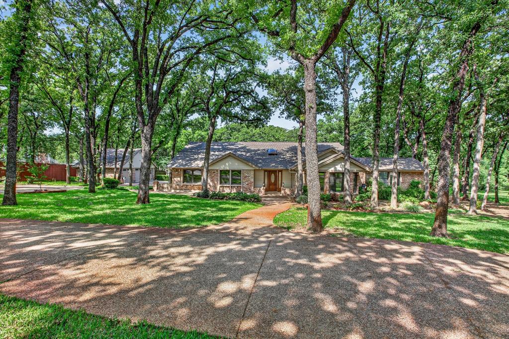 **Timeless Charm Meets Modern Luxury in Euless**Introducing an exquisite sanctuary nestled in the heart of Euless, TX, this stunning Global Luxury property is the epitome of refined living. With 4 bedrooms, 3 baths, and  5-car garage spaces,  this ranch-style residence offers the perfect blend of elegance and functionality while being secluded on a beautifully landscaped lot adorned with majestic soaring trees.Step inside to experience the seamless flow of the open-concept living and kitchen area. Bathed in natural light, the spacious living room boasts high ceilings and a sophisticated fireplace, setting the stage for both grandeur and coziness. The designer kitchen is a culinary masterpiece equipped with top-of-the-line stainless steel appliances, marble countertops, a large center island with seating, and custom cabinetry that will surely inspire any chef.Retreat to the sumptuous primary suite, which offers tranquil garden views and a luxurious spa-like bath complete with dual vanities, a soaking tub, and a deluxe walk-in shower. Three additional generously-sized bedrooms provide ample space for comfort and privacy for every member of the household.Outside, the enchanting lot presents unparalleled beauty and privacy. Lush landscaping frames the property, complemented by stone pathways and a grand outdoor entertaining area ideal for al fresco dining or simply relaxing in the serene environment. Mature trees offer shade and a picturesque backdrop, making this an idyllic escape from the hustle and bustle.Car enthusiasts will revel in the expansive detached 3 car garage, providing an abundance of space for vehicles and storage. This exceptional property truly embodies luxury and convenience, offering an extraordinary lifestyle opportunity in the coveted Euless area. Experience unparalleled elegance in this exceptional home where timeless charm meets modern luxury.