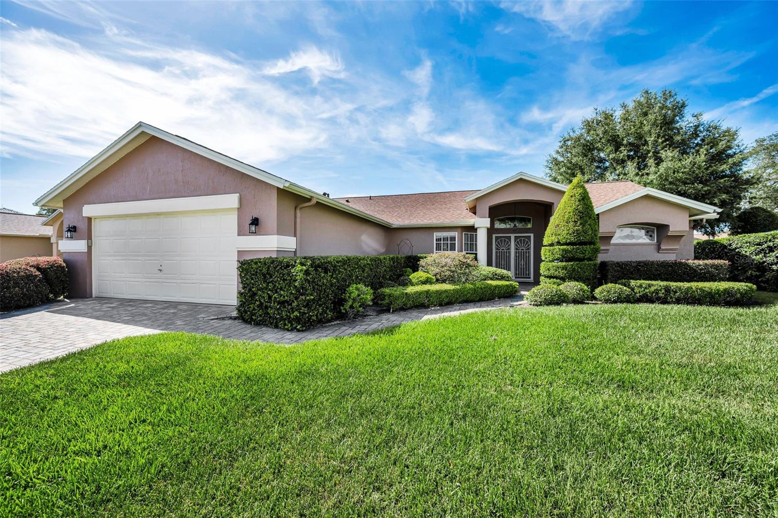 Virtually Staged. Beautiful Beacon Woods Golf Community Home at an Incredible Value! Come check out this inviting 2-bedroom, 2-bathroom home with a 2-stall garage, located in the desirable Beacon Woods Estates. Offering a spacious layout, open concept, high ceilings, and a great price, this home is an excellent opportunity for comfortable Florida living. The open-concept kitchen and living area creates a bright, welcoming space that is perfect for everyday living and entertaining. A split-bedroom floor plan provides added privacy, while the high ceilings enhance the feeling of openness throughout the home. The home features new ceramic tile flooring, adding a clean, modern touch and making maintenance a breeze. The 2-car garage also features new epoxy flooring, giving the space a polished appearance while providing a durable surface for parking, hobbies, or additional storage.One of the home's standout features is the large screened-in lanai, offering an ideal spot to relax, entertain, or enjoy the beautiful Florida weather year-round. Need additional space? The home also offers a flexible room that could be used as a possible third bedroom, office, den, or hobby room, depending on your needs. Roof is 2024.Located in Beacon Woods, a popular golf community with a low HOA, No flood zone, this property offers an appealing combination of lifestyle and affordability. Whether you're looking for a full-time residence, seasonal home, or investment opportunity, this one is worth a look. Great location. Great features. Great value — don't miss this opportunity in Beacon Woods!