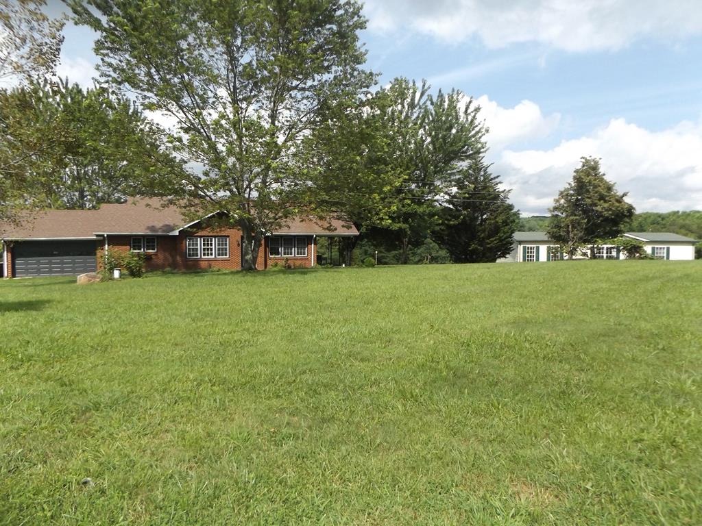 Mini farm with 2 homes on 10.00+/- acres! Recently updated 2 bedroom full bathroom brick home with main level living! Home features large living room, updated kitchen with all major appliances, formal dining room, master bedroom, full bathroom, guest bedroom and laundry! Other features include heat pump, full basement, attached garage and covered carport! Second home is like new and features large kitchen, large living room with rock fireplace, dining area, master suite with walk-in closet, master bathroom with garden tub and walk-in shower, 2 nice sized guest bedrooms, hallway bathroom and the list goes on! On the outside you will find 10.00 +/- acres to enjoy with multiple barns mostly pasture land with long range countryside views! Don't miss out on this fantastic property that offers so much potential in a convenient location joining the Blue Ridge Parkway!