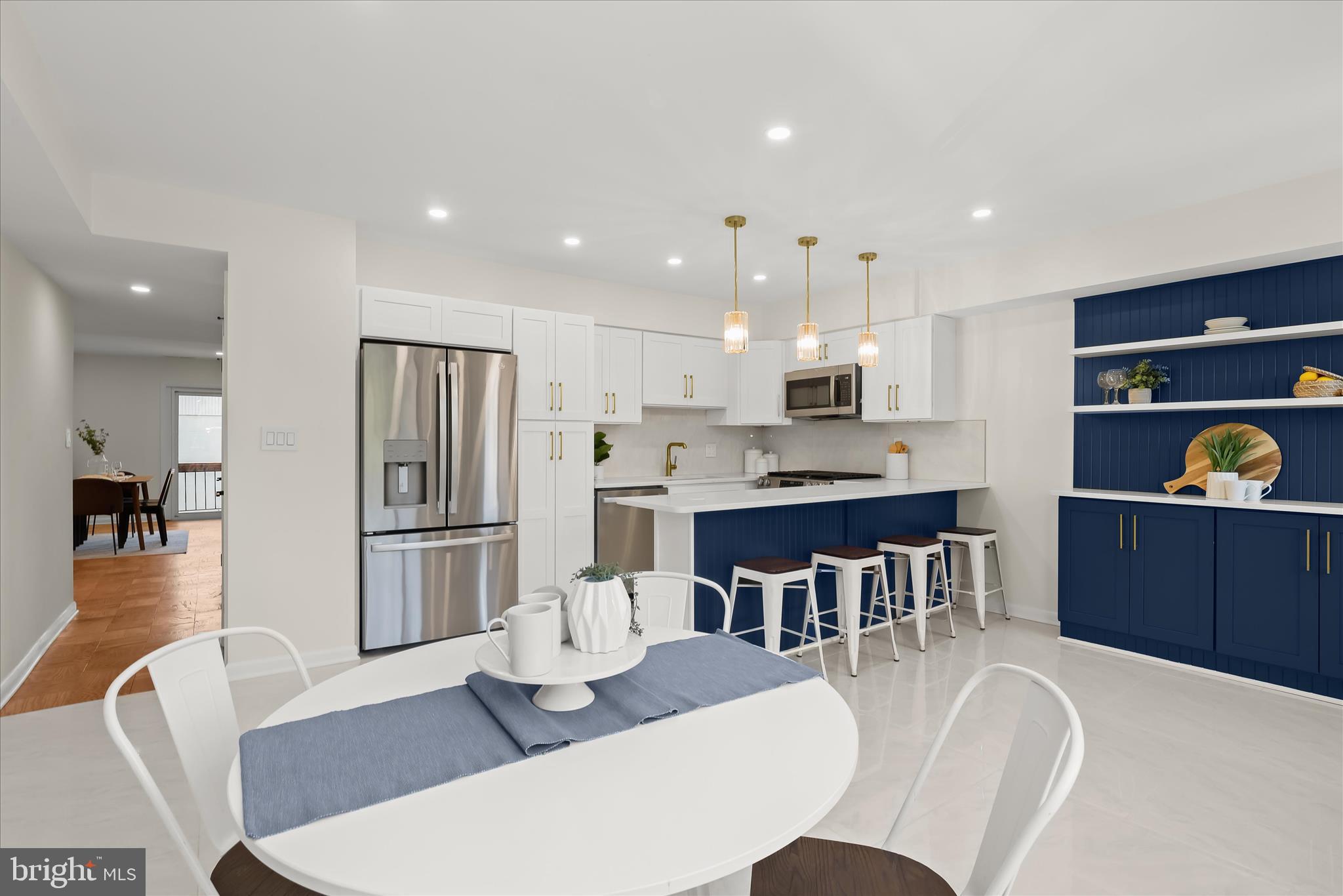 Introducing this fully renovated penthouse condo in the sought-after Cross Keys community, offering two bedrooms and two and a half bathrooms across two beautifully updated levels. A bright, open layout welcomes you inside, where the dining and living areas feature wood floors and sliding glass doors that lead to a private balcony. The showpiece eat-in kitchen impresses with stainless steel appliances, quartz counters and backsplash, soft-close shaker cabinetry, a breakfast bar, and a cozy nook for casual dining. A half bathroom completes the main level. Upstairs, wood floors continue into each bedroom that offers its own ensuite bathroom. The primary suite showcases a private balcony, dual closets, and a walk-in shower, while the second bedroom includes a walk-in closet and a tub/shower. A laundry closet with hookups provides added convenience to this level. Enjoy the vibrant, gated Cross Keys lifestyle with access to three swimming pools, tennis courts, walking paths, and more. The revitalized Village of Cross Keys offers an array of shops, boutiques, restaurants, services, and offices, all tucked within a tranquil garden setting surrounded by lush greenery.