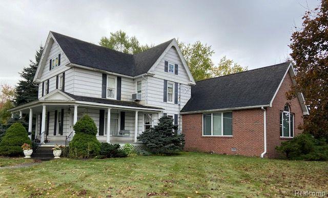 Discover this enchanting 3,139 sq ft home set on almost 2 acres with a large circle drive. Located between Grand Blanc and Holly, just minutes from I-75, Shopping, Great Lakes National Cemetery & Henry Ford Genesys Hospital. This property welcomes with numerous possibilities & amenities. This stunning home boasts a spacious & covered wrap around porch, granting a centrally located front entrance. And a private rear fenced sitting area, perfect for a tranquil early morning cup of coffee as you lounge in your favorite chair or the included hot tub.
Entering the home you will find handcrafted trim & woodwork. The former owner, a talented artist, created several unique stained glass windows, which bring an artistic flair to the home.

The main living area features a large living room with a natural stone accent wall fireplace, warming the house on those chilly winter evenings. The open concept kitchen is a cook's delight with a large island, pantry storage, and well-lit workspaces. Also included in the main living area: roomy parlor with a large picture window, formal dining room-perfect for your harvest table & family gatherings, full bath & spectacular two story great room. This inviting layout boasts extensive space for relaxing or hosting large holiday gatherings, with the recently added great room providing a perfect showcase for the most majestic of Christmas trees.
The upstairs features 5 large bedrooms, a full bath & walk in attic. The charming basement is an added bonus, completing the home with plenty of space for a workshop & hobby area.
Bring all your toys - the property includes a large & small tool shed, a large 1300sq ft 3 car garage. Plus a rare, impressively sized 5500sq ft warehouse with office & bath, includes extensive amenities: 3 phase power, heat & C/A & large overhead door. An enthusiasts dream, perfect for an office, dream workshop or car collection, the possibilities are endless. A must see... A truly unique opportunity for a Family, Hobbyist, Collector, Car Enthusiast, and more...