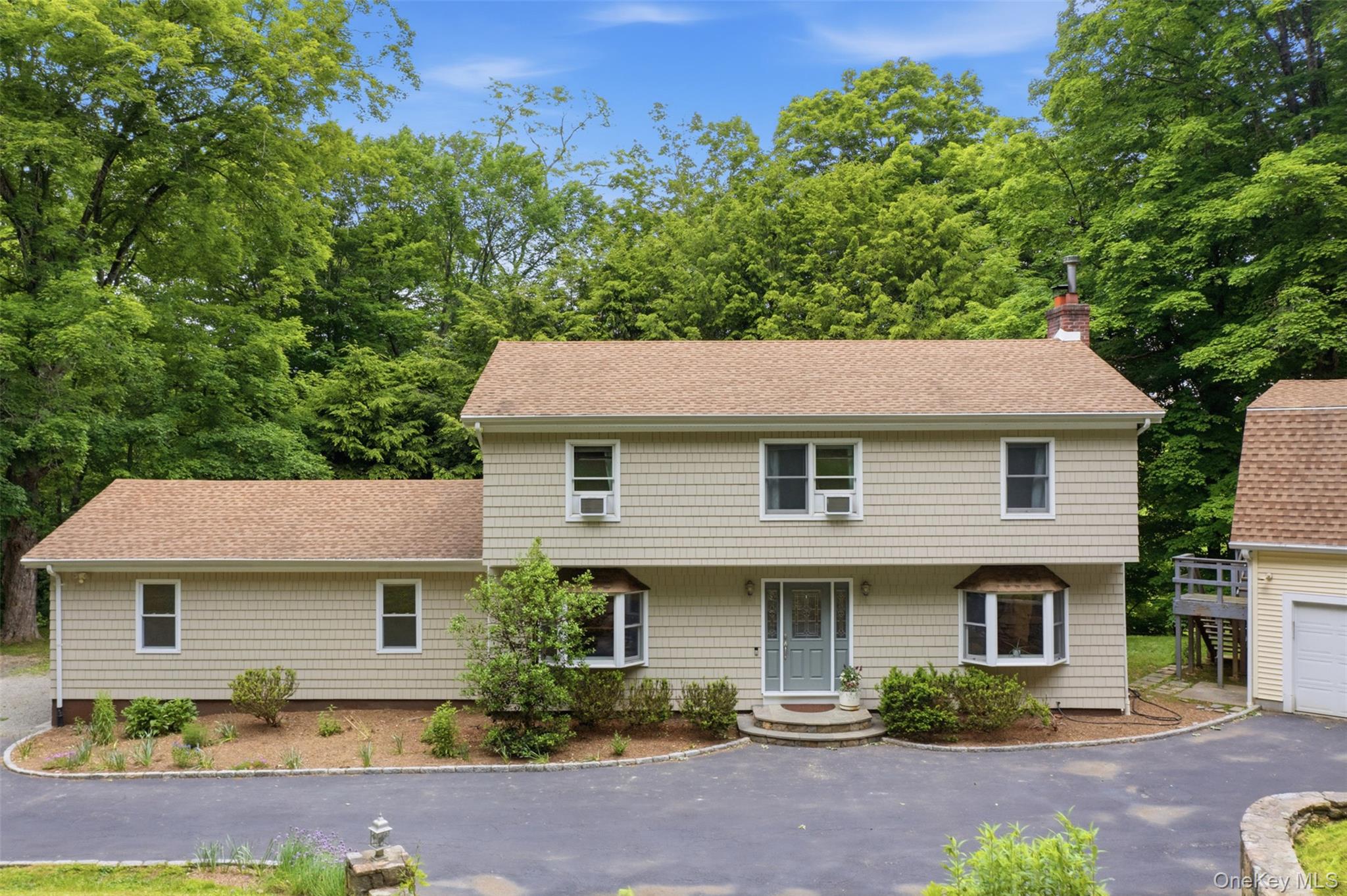 Private updated retreat within minutes to Scott's Corners, and across the street from Pound Ridge Town Park. Enjoy the wood burning fireplace in the living room, updated kitchen with new appliances, updated baths, and hardwood floors throughout. Easy flow with rooms bathed in natural light and deck off kitchen makes entertaining, or basking in the sun, a breeze. This home sits on 2.81 private acres, with a long driveway and mature trees. For the car and storage fanatics, this home boasts a two car garage on the main house and another three car detached garage on property. Use for storage galore, to work on cars, or even rent out the additional space to car enthusiasts. Recent updates include: New roof 2016, new septic fields 2021, new windows, new driveway, new bib in garage, newly done retaining wall, and freshly painted! Don't miss this hilltop charmer.