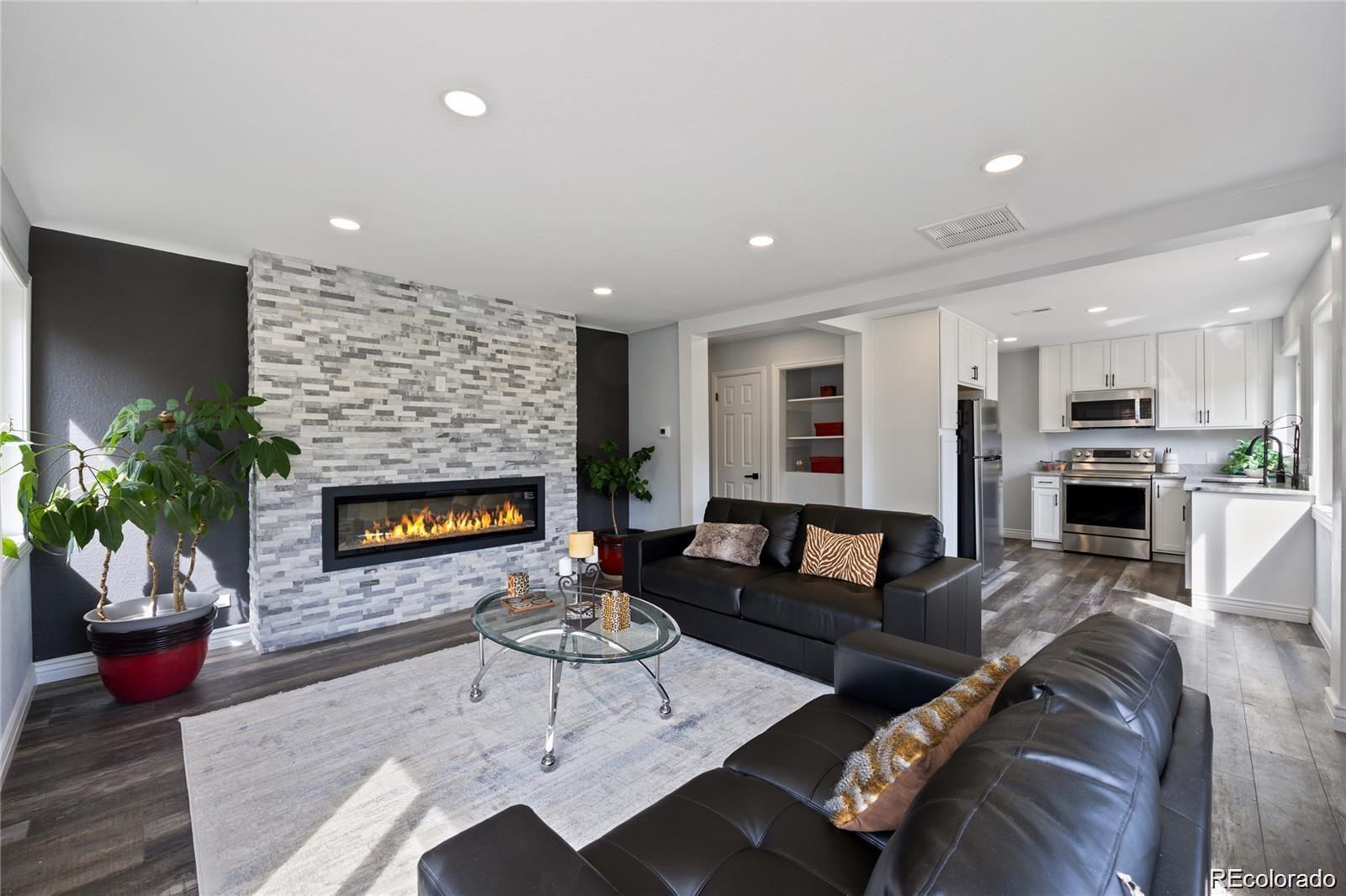 Step inside this beautifully remodeled Mayfair Neighborhood gem. From the moment you walk in, the bright, open living room welcomes you with warm natural light, gleaming luxury vinyl plank flooring, and fresh, crisp paint that sets the tone for a space designed to both relax and inspire. The modern kitchen is as functional as it is beautiful, showcasing Calacatta stone countertops that add a touch of elegance, paired perfectly with new wood cabinets and stainless steel appliances. Whether you're whipping up a quiet weeknight dinner or preparing a feast for guests, this kitchen is designed to inspire. Nearby, the dining area, with its charming French doors, opens effortlessly to the back yard, creating the perfect indoor-outdoor flow for entertaining under the stars. Step outside to a back yard made for memories: an updated deck, a single covered carport for extra parking, projects, or just additional covered patio space. Don’t miss the rare oversized two-car garage with a bonus door opening to the yard — whether you’re hosting a barbecue, working in the garage, or unwinding after a long day, this home blends comfort, style, and functionality in every corner. There’s room for everyone with four total bedrooms—two upstairs and two more in the beautifully finished basement—along with updated bathrooms, including a spa-like lower-level retreat featuring a tiled shower and double vanity. Recent upgrades like a newer roof, a brand-new electrical panel, new water heater, and new central A/C give you peace of mind—leaving you free to simply enjoy the space and start your next chapter!!