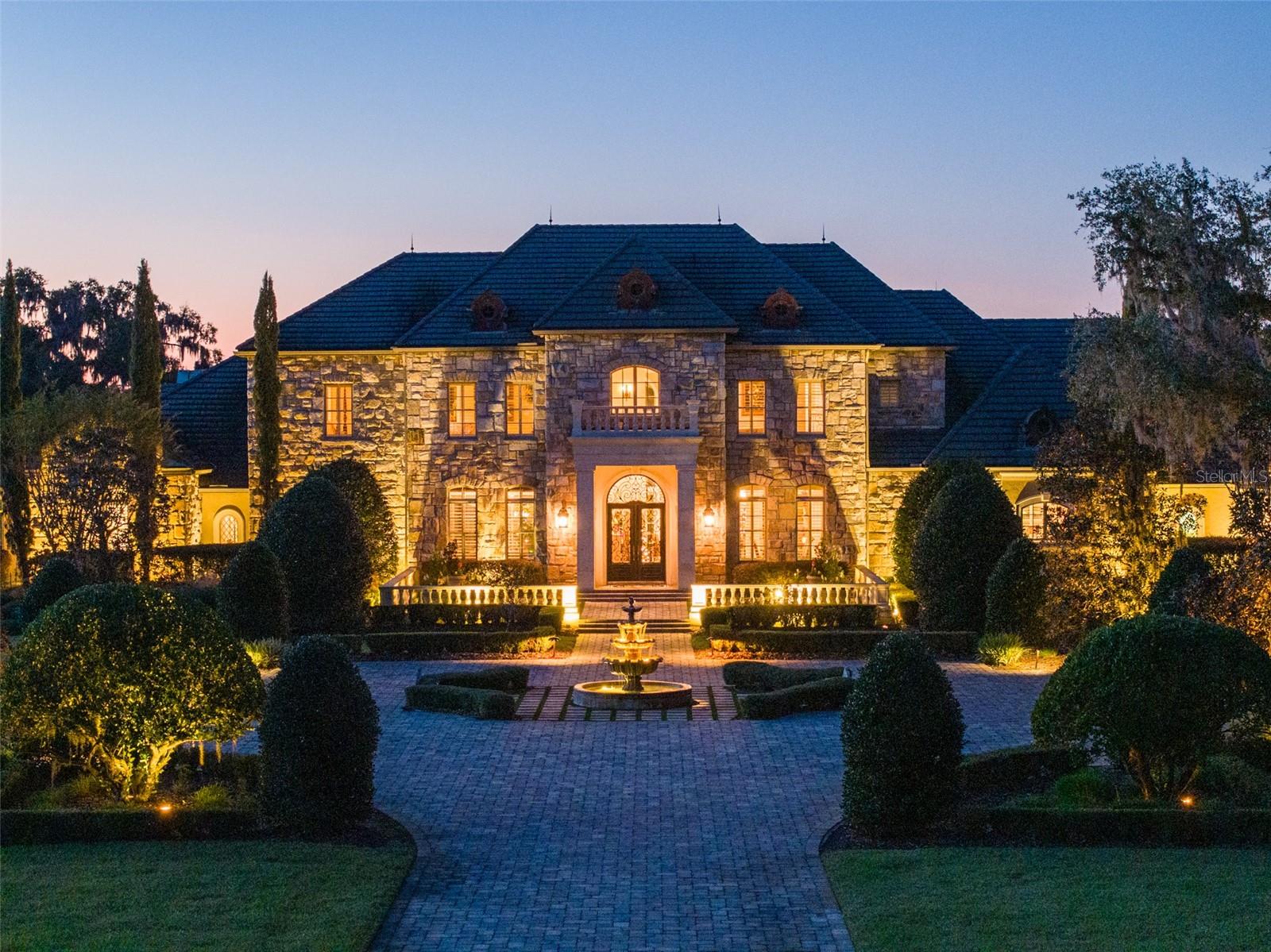 10 +/- Acre Incredible French Country Estate offers peace, privacy, and the enjoyment of having your own private estate. Magnificent, professionally designed, and sculpted 7,918 +/- SF 5-bedroom, 5.5 bath stone residence combines the best of elegance, style, and craftsmanship and offers gorgeous, expansive views of the surrounding Granddaddy Oaks and grounds. The foyer opens to a grand staircase, formal dining, and a large living room with a carved stone fireplace. Beautiful chef’s kitchen with hidden pantry, butler’s pantry, expansive center island, the bar seats five, and a separate family room with fireplace and family dining area. The open floor plan makes the home perfect for entertaining friends and family. French doors open onto expansive verandas with a summer kitchen, outdoor dining, and gathering areas around a double-sided fireplace overlooking an exquisite pool. Spacious owner’s suite offers a seating area, dual closets, and access to the pool. The incredible features that make this French home elegant and warm include Travertine floors, soaring architectural ceilings, impressive beam works, five fireplaces, and intricate moldings. Private office, exercise room, wine room, game room with beautiful beverage bar and seating area for watching games, planning your next duck, deer, or turkey hunt. This resort-like property is unsurpassed. 4- Car garage. Located just minutes from Williston airport.  Additional adjoining acreage is also available.